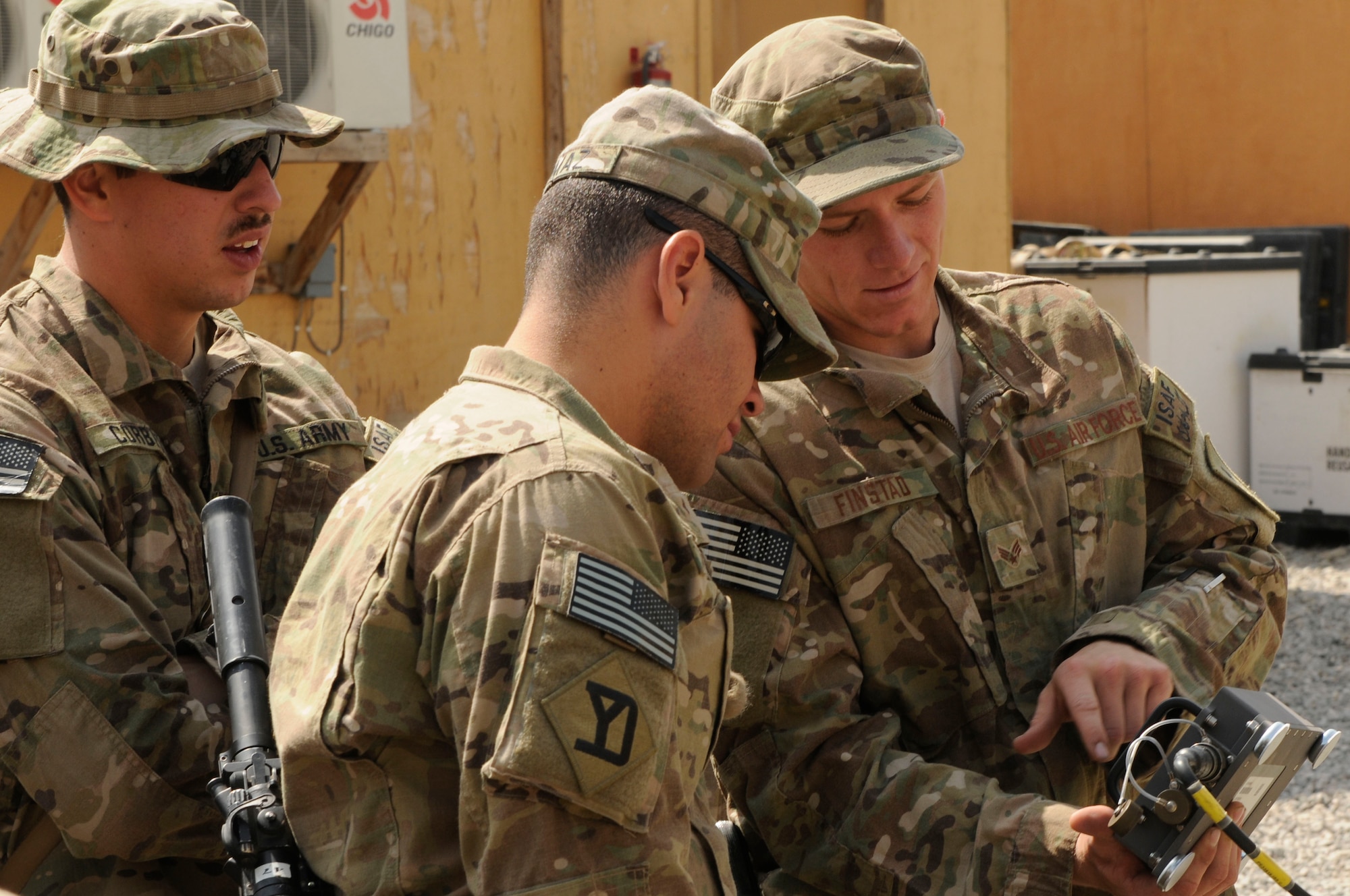 Senior Airman Robert Finstad, Provincial Reconstruction Team Paktya master driver, explains the operation of a mine roller controller to members of the PRT security forces, July 26, 2011. Finstad helps insure that all vehicle drivers are trained and current on vehicle capabilities. (U.S. Air Force/Senior Airman Wesley Farnsworth)
