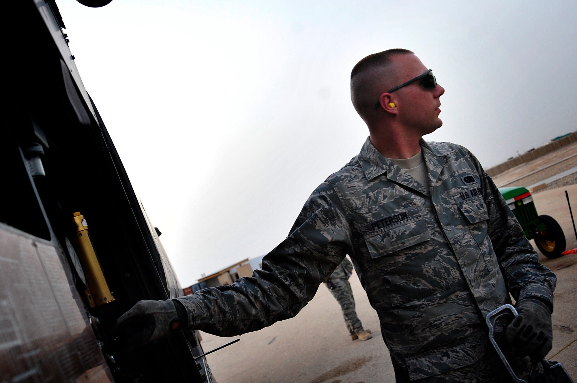 Airman 1st Class David Peterson, 407th Air Expeditionary Group fuels equipment specialist, refuels a Bell UH-1 Iroquois helicopter at Ali Base, Iraq, Aug. 24, 2011. He is deployed from Minot Air Force Base, N.D., and is from Tuscon, Ariz. (U. S. Air Force photo/Master Sgt. Cecilio Ricardo)