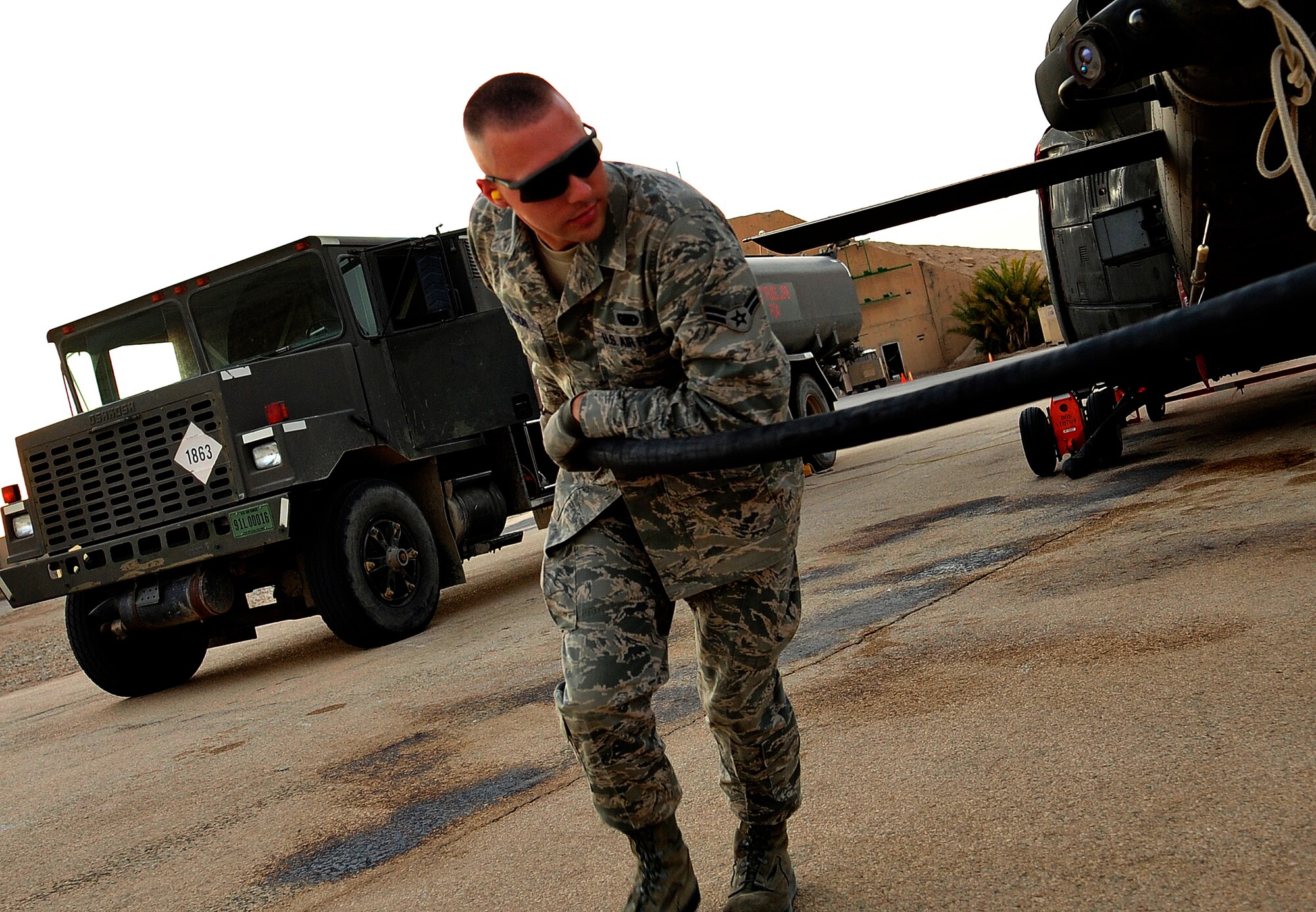 Airman 1st Class David Peterson, 407th Air Expeditionary Group fuels equipment specialist, prepares to refuel a Bell UH-1 Iroquois helicopter at Ali Base, Iraq, Aug. 24, 2011. He is deployed from Minot Air Force Base, N.D. and is from Tuscon, Ariz. (U. S. Air Force photo/Master Sgt. Cecilio Ricardo)