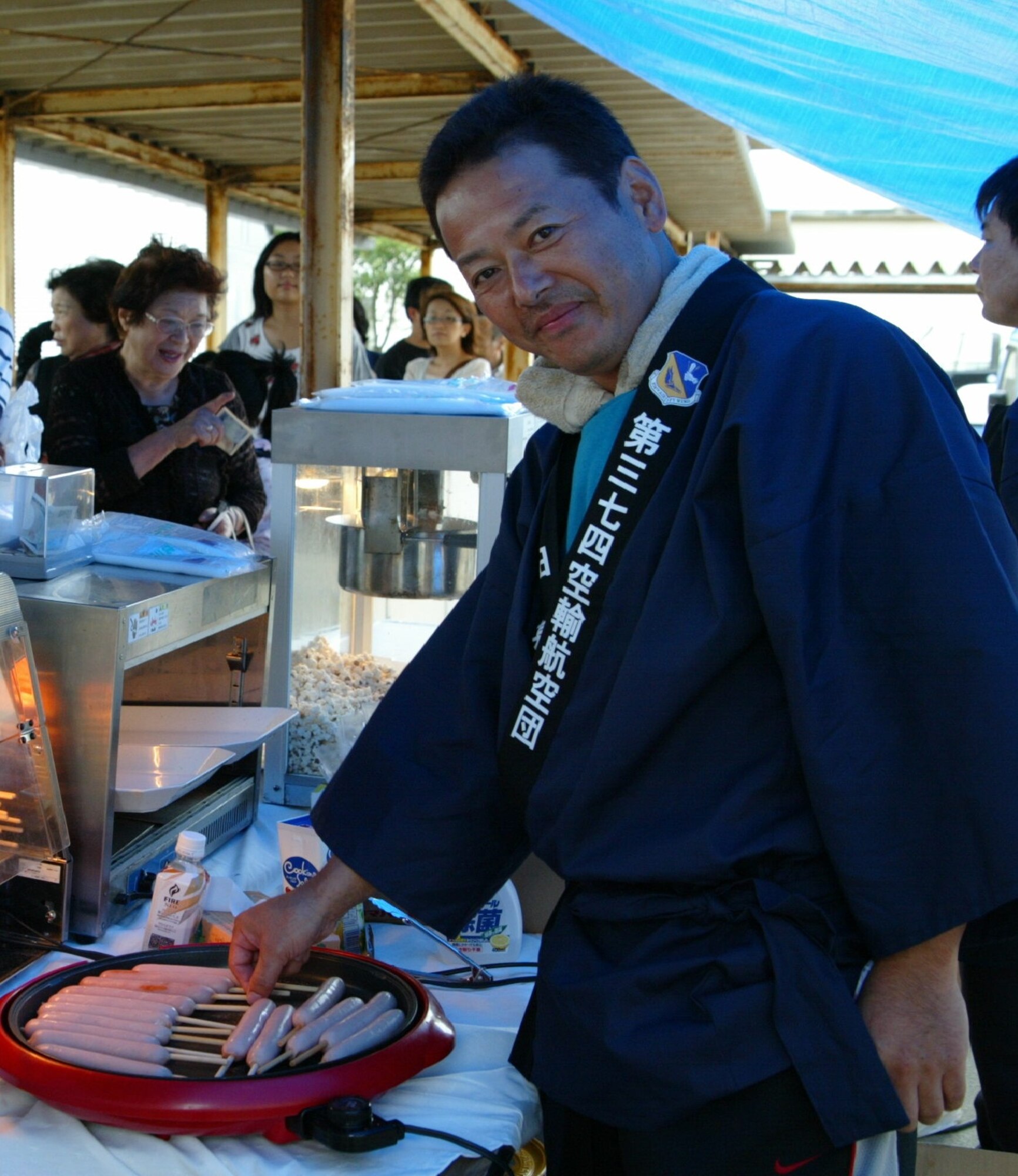 SENDAI, JAPAN—A Japanese relief worker immediately puts on his gift yukata presented by the PACAF Band leadership on behalf of Yokota AB.  Sep 2011 (courtesy photo)