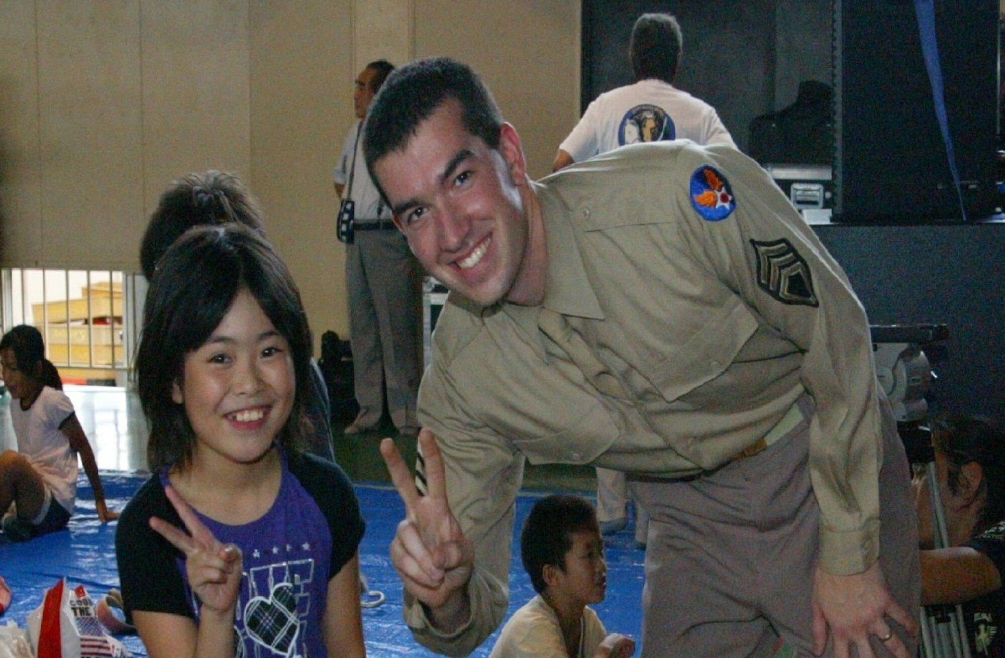 SENDAI, JAPAN--A1C Jordan Kimble snaps a picture with a young audience member. Sep 2011. (courtesy photo)