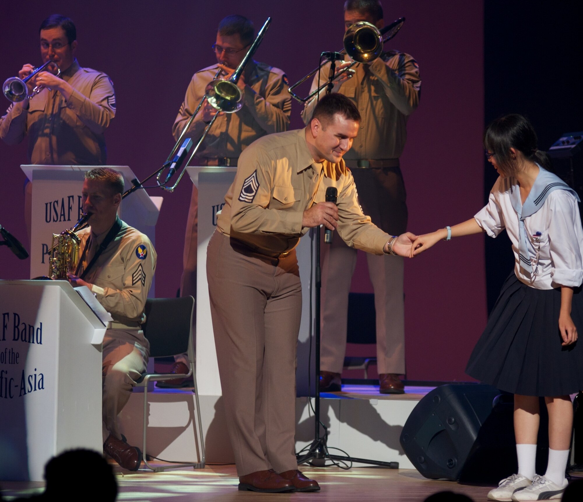 IWATE, JAPAN-- SrA William Pressgrove invites a student on stage to dance with the band. Sep 2011. (courtesy photo)