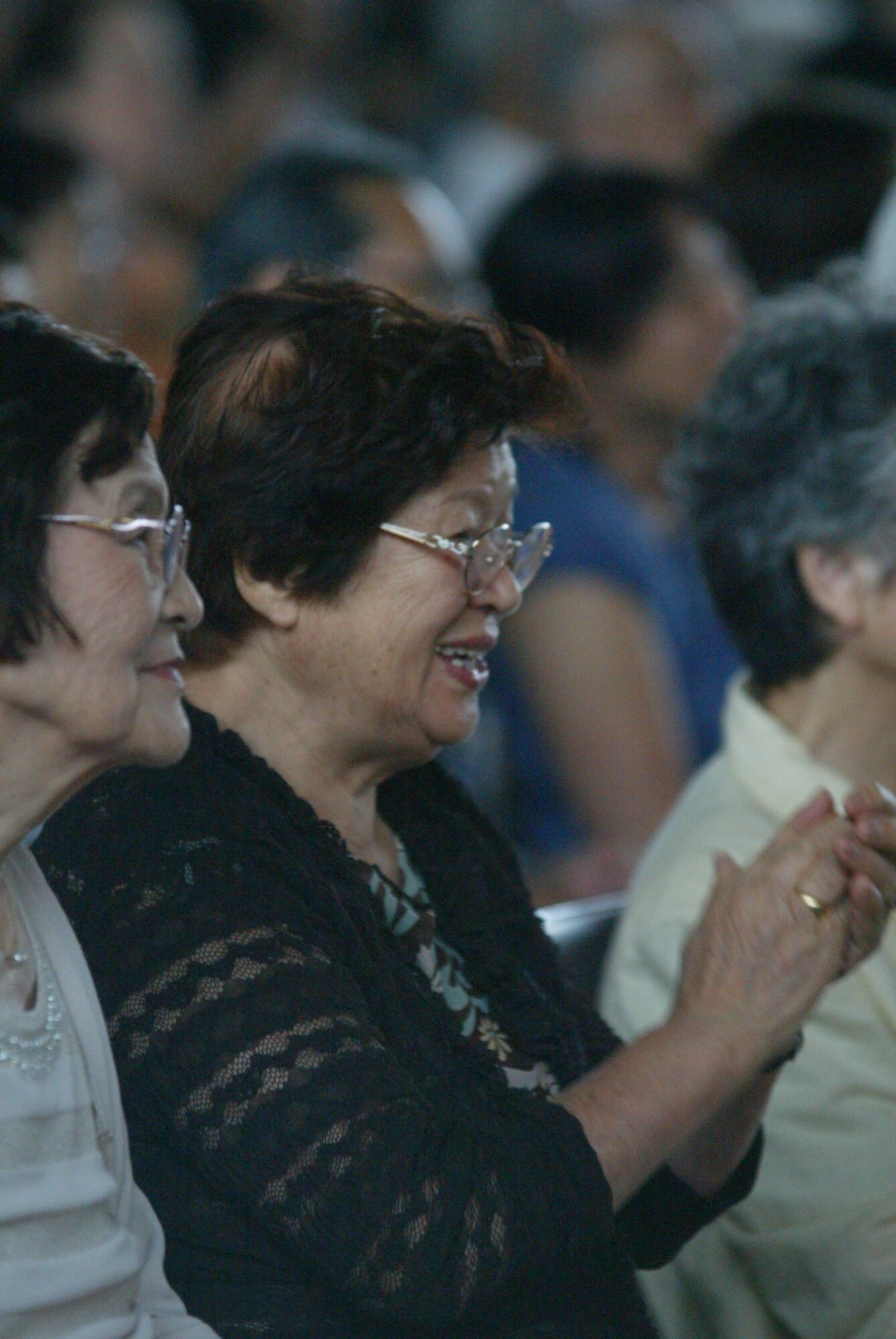 FUKUSHIMA, JAPAN--An audience member claps and smiles during an Air Force Band of the Pacific performance. Aug 2011.  (courtesy photo)