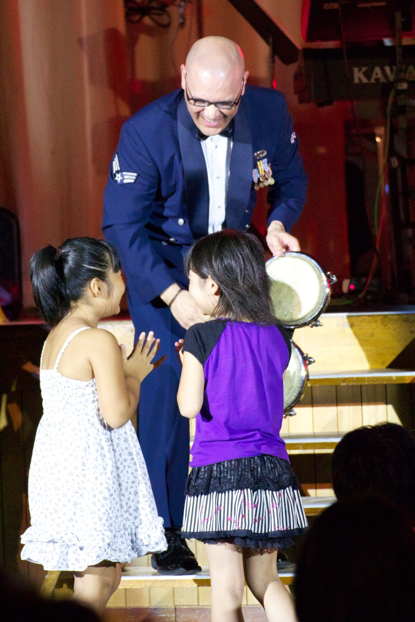 KITAKAMI, JAPAN--SSgt Freddie Cruz gives a couple brave young children a chance to play with the band. Sep 2011.  (courtesy photo)