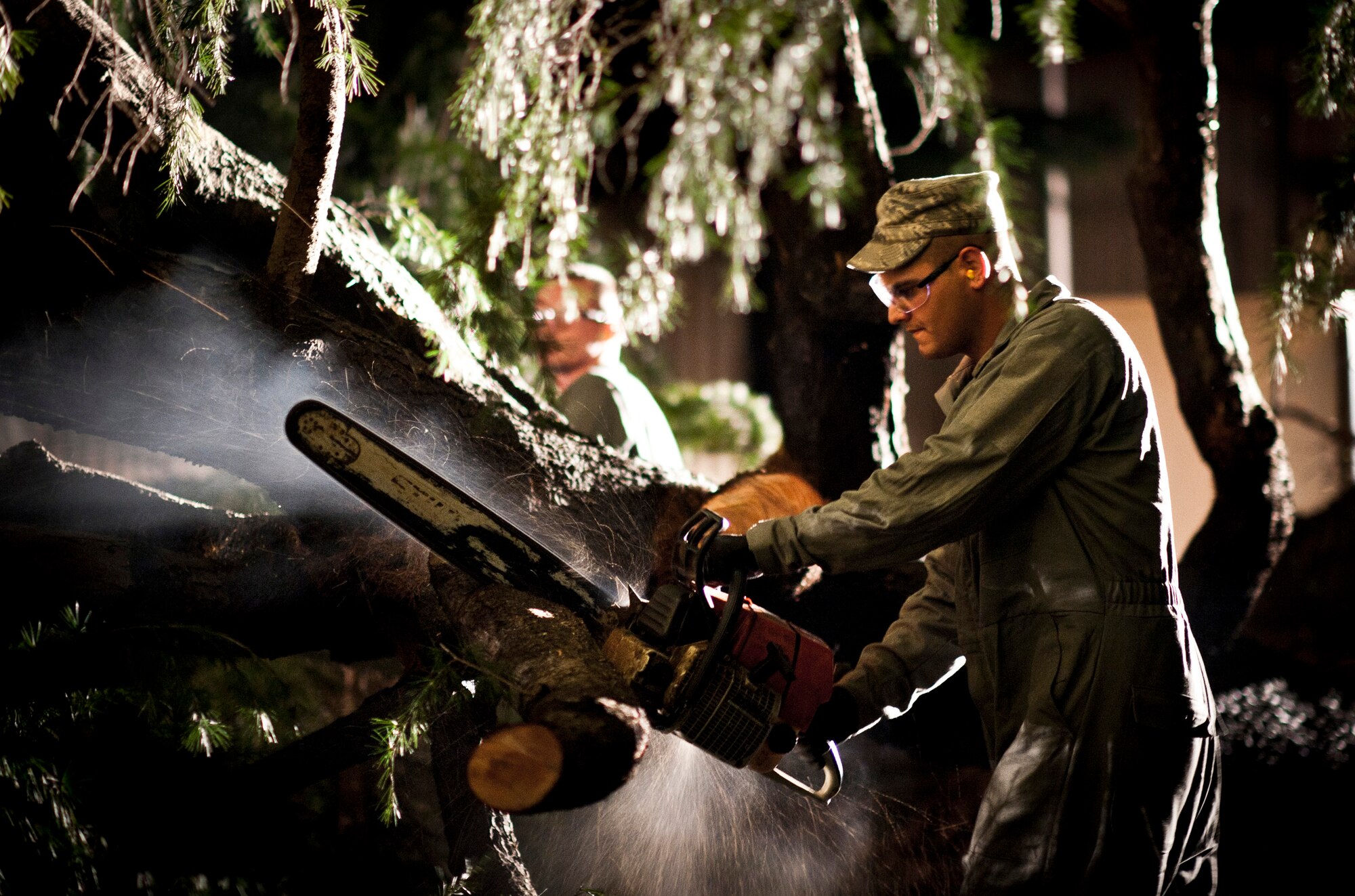YOKOTA AIR BASE, Japan -- A "dirt boy" from the 374th Civil Engineer Squadron cuts up a downed tree from Tropical Storm Roke Sep. 21, 2011, at Yokota Air Base, Japan. (U.S. Air Force photo/Staff Sgt. Samuel Morse)