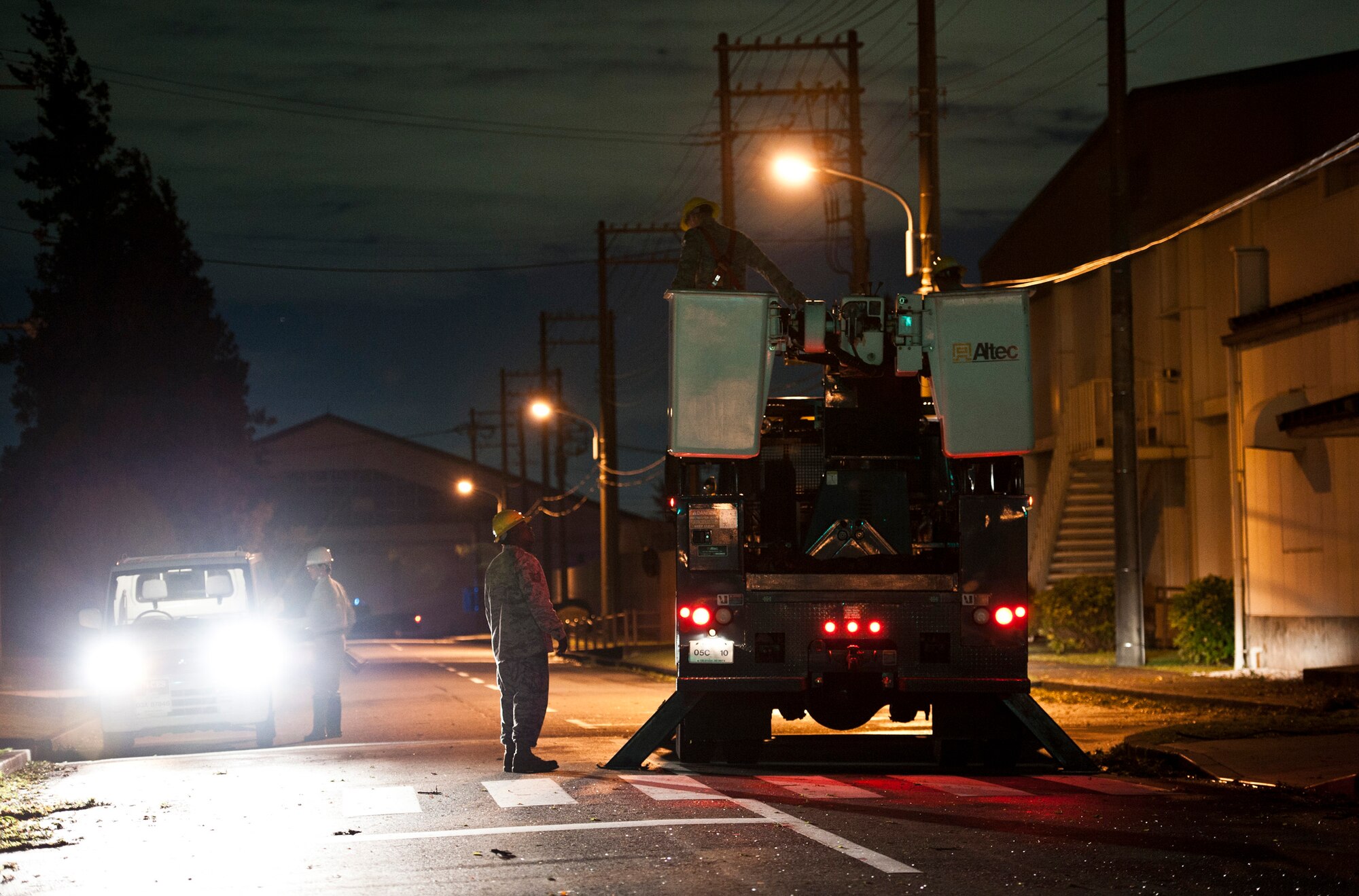 YOKOTA AIR BASE, Japan -- Electricians from the 374th Civil Engineer Squadron prepare to fix a downed power line after Tropical Storm Roke hit Sep. 21, 2011, at Yokota Air Base, Japan. (U.S. Air Force photo/Staff Sgt. Samuel Morse)