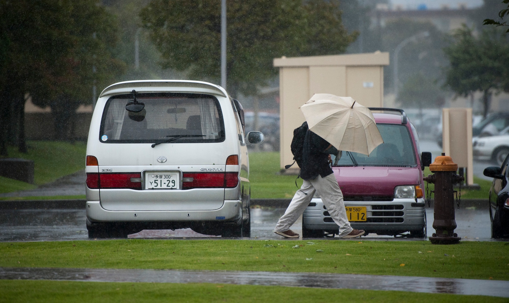 YOKOTA AIR BASE, Japan -- A man wards off rain and wind from Tropical Storm Roke Sep. 21, 2011, at Yokota Air Base, Japan. (U.S. Air Force photo/Staff Sgt. Samuel Morse)