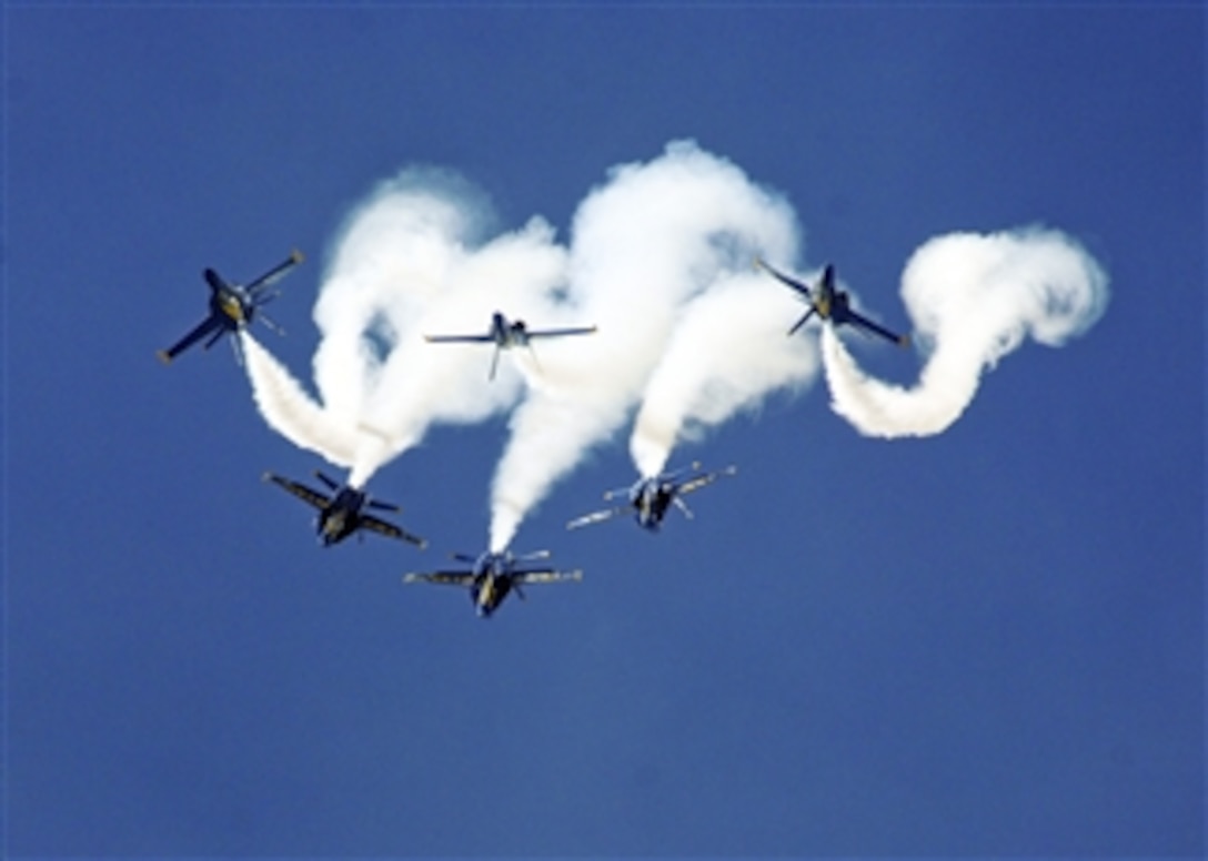 The U.S. Navy Flight Demonstration Squadron, the Blue Angels, perform the Loop Break Cross maneuver at the Guardians of Freedom Air Show in Lincoln, Neb., on Sept. 11, 2011.  The Blue Angels performed in Lincoln as part of the 2011 show season and in celebration of the Centennial of Naval Aviation.  