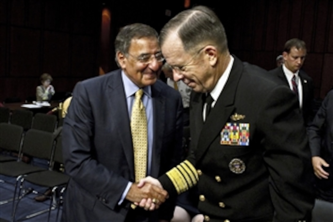 Defense Secretary Leon E. Panetta congratulates Navy Adm. Mike Mullen, chairman of the Joint Chiefs of Staff, at the conclusion of what was Mullen'ss last appearance before the Senate Armed Services Committee, Sept. 22, 2011. Mullen will retire after more than 40 years of military service, Sept. 30, 2011. 