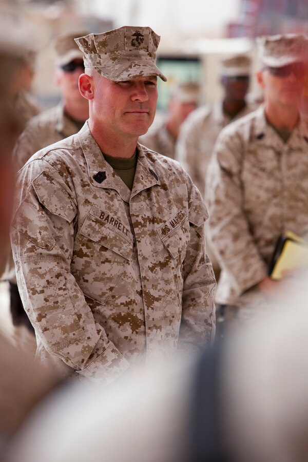 John Mahoney, vice president, Chevron, presents a project completion plaque to Col. Terry V. Williams here, Friday.
