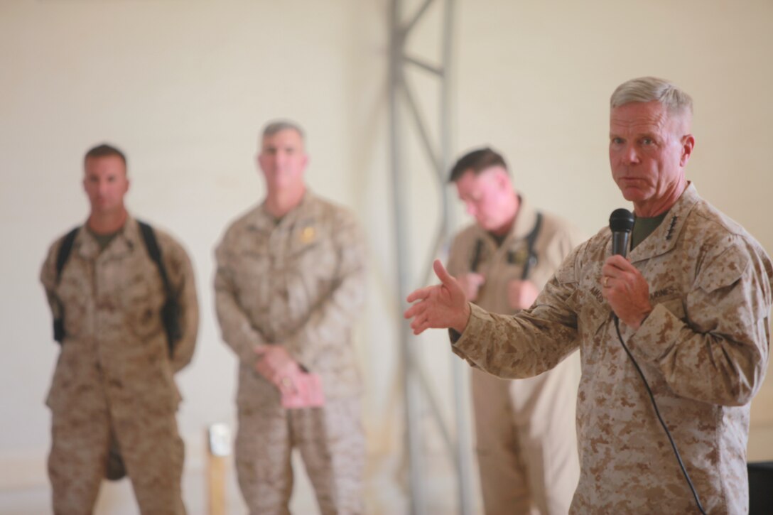 Gen. James F. Amos, commandant of the Marine Corps, addresses the Marines of 2nd Marine Aircraft Wing (Forward) at Camp Leatherneck, Afghanistan, Sept. 23 as Master Sgt. Michael D. Noble, the senior enlisted advisor of Marine Wing Headquarters Squadron 2; Maj. Gen. Glenn M. Walters, commanding general 2nd Marine Aircraft Wing (Forward); and Lt. Gen. Terry G. Robling, deputy commandant of the Marine Corps for aviation; listen in the background.
