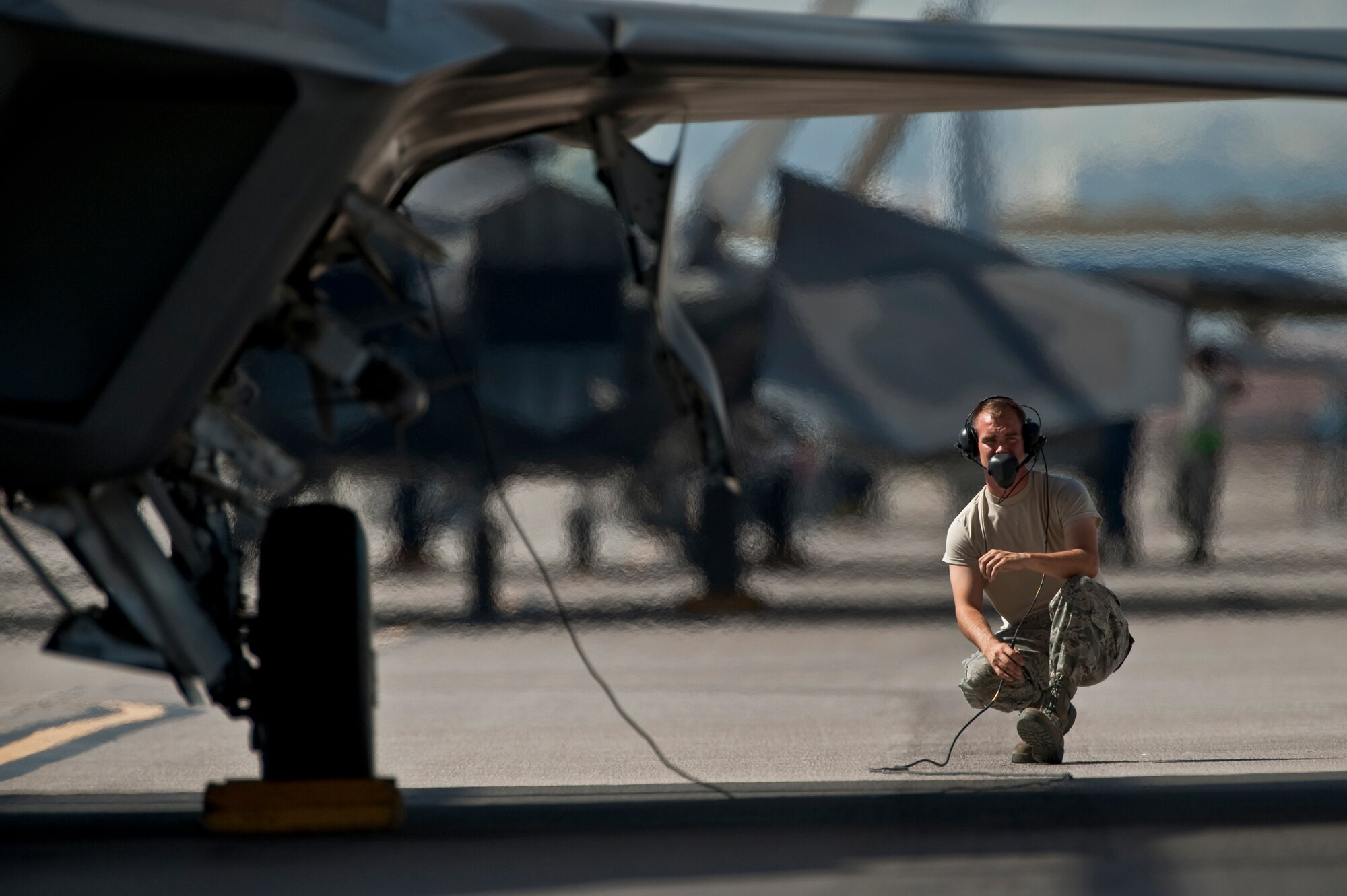 U.S. Air Force Staff Sgt. Ian-Wayne Thorton, 57th Aircraft Maintenance Squadron crew chief, goes over pre-flight check before launching a F-22 Raptor Sept. 21, 2011, at Nellis Air Force Base Nev., for its first flight since an Air Combat Command directed stand-down of the entire F-22 fleet May 3, 2011. The Raptors were grounded as a safety precaution, following 12 separate reported incidents where pilots experienced hypoxia-like symptoms. Officials remain focused on the priorities of aircrew safety and combat readiness. The return-to-fly plan implements several risk-mitigation actions, to include rigorous inspections, training on life-support systems and continued data collection. (U.S. Air Force photo by Tech. Sgt. Michael R. Holzworth/Released)

