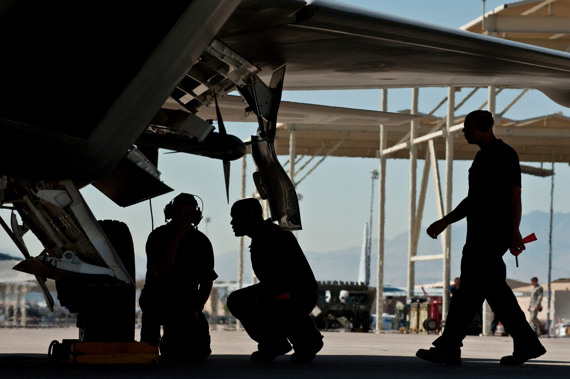 U.S. Air Force Crew Chiefs from the 57th Aircraft Maintenance Squadron  goes over pre-flight procedures  before launching a F-22 Raptor Sept. 21, 2011, at Nellis Air Force Base Nev., for its first flight since an Air Combat Command directed stand-down of the entire F-22 fleet May 3, 2011. The Raptors were grounded as a safety precaution, following 12 separate reported incidents where pilots experienced hypoxia-like symptoms. Officials remain focused on the priorities of aircrew safety and combat readiness. The return-to-fly plan implements several risk-mitigation actions, to include rigorous inspections, training on life-support systems and continued data collection. (U.S. Air Force photo by Tech. Sgt. Michael R. Holzworth/Released)

