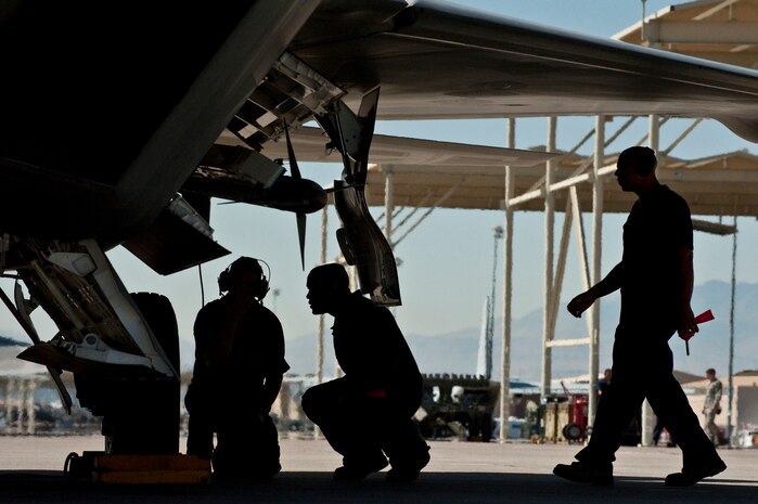 U.S. Air Force Crew Chiefs from the 57th Aircraft Maintenance Squadron  goes over pre-flight procedures  before launching a F-22 Raptor Sept. 21, 2011, at Nellis Air Force Base Nev., for its first flight since an Air Combat Command directed stand-down of the entire F-22 fleet May 3, 2011. The Raptors were grounded as a safety precaution, following 12 separate reported incidents where pilots experienced hypoxia-like symptoms. Officials remain focused on the priorities of aircrew safety and combat readiness. The return-to-fly plan implements several risk-mitigation actions, to include rigorous inspections, training on life-support systems and continued data collection. (U.S. Air Force photo by Tech. Sgt. Michael R. Holzworth/Released)

