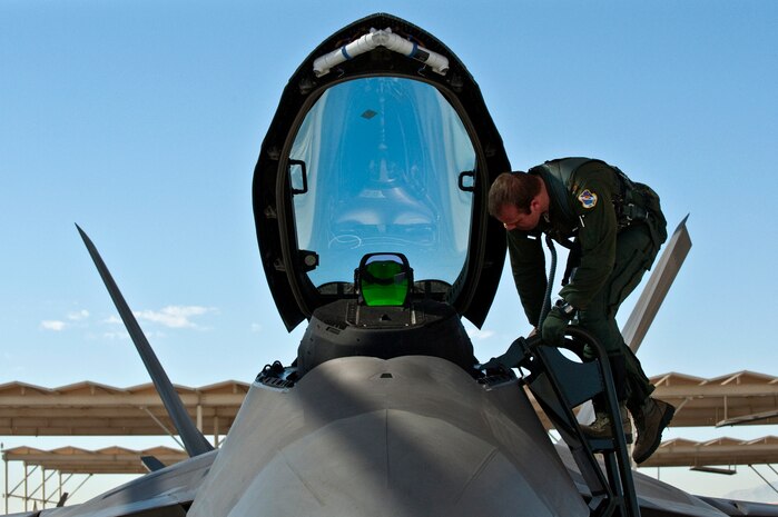 U.S. Air Force Maj. Matt Allen, 422nd Test and Evaluation Squadron pilot, climbs into the cockpit of a F-22 Raptor Sept. 21, 2011, at Nellis Air Force Base Nev., for his first flight since an Air Combat Command directed stand-down of the entire F-22 fleet May 3, 2011. The Raptors were grounded as a safety precaution, following 12 separate reported incidents where pilots experienced hypoxia-like symptoms. Officials remain focused on the priorities of aircrew safety and combat readiness. The return-to-fly plan implements several risk-mitigation actions, to include rigorous inspections, training on life-support systems and continued data collection. (U.S. Air Force photo by Tech. Sgt. Michael R. Holzworth/Released)
