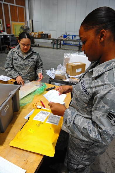 Senior Airman Shannon Tanksley, right, and Airman 1st Class Laura Barela, 7th Logistics Readiness Squadron, sort through deliveries Sept. 22, 2011 at Dyess Air Force Base, Texas. TMO’s inbound section unloads, sorts and distributes inbound materials to Dyess. (U.S. Air Force photo by A1C Peter Thompson/Released)