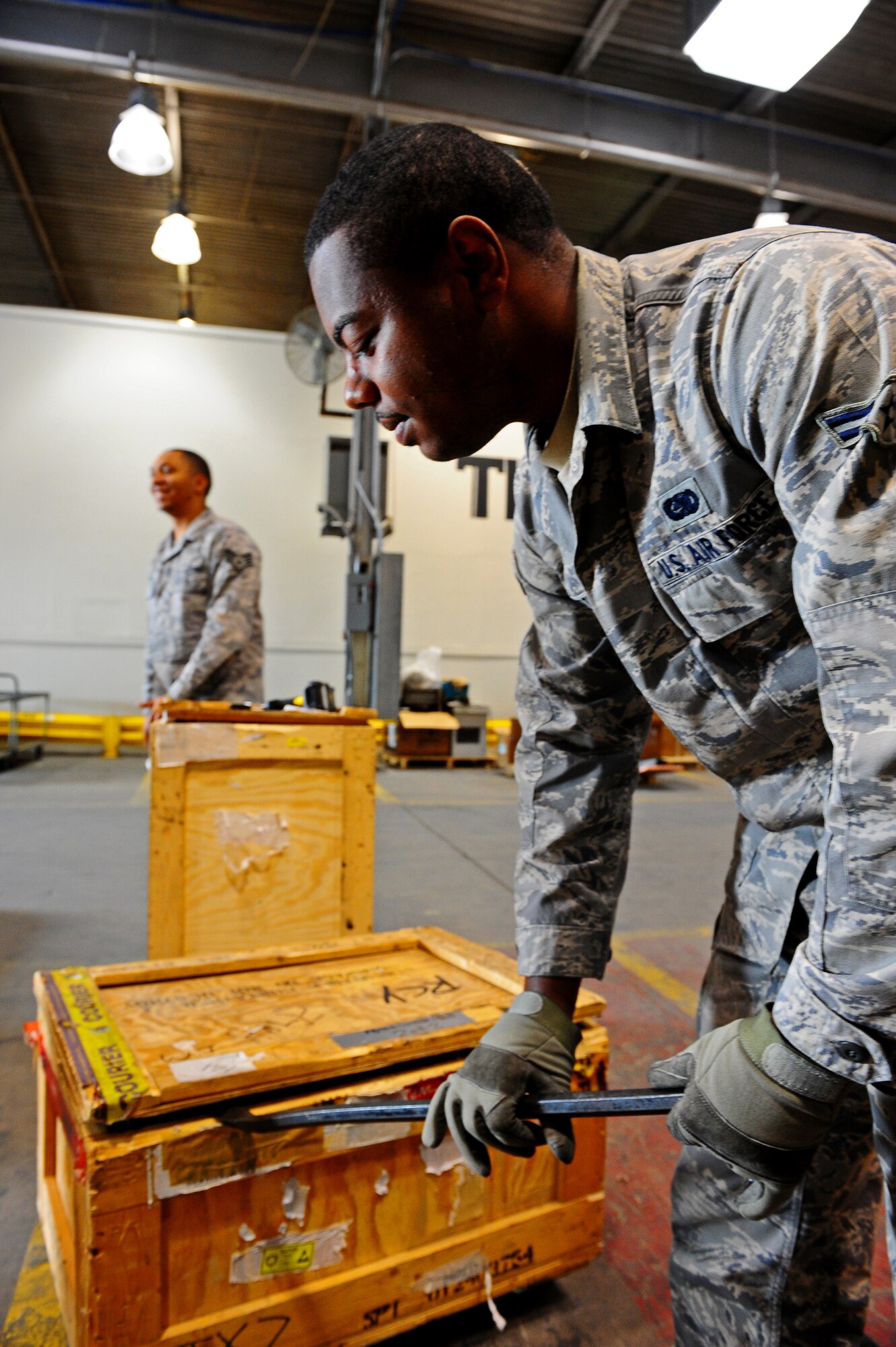 Airman 1st Class Aaron Shelton, 7th Logistics Readiness Squadron, opens a shipment Sept. 22, 2011 at Dyess Air Force Base, Texas. TMO’s inbound section unloads, sorts and distributes inbound materials to Dyess. (U.S. Air Force photo by Airman 1st Class Peter Thompson/Released)