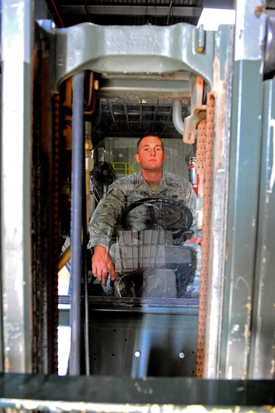 Airman 1st Class Adam Manuel, 7th Logistics Readiness Squadron operates a forklift Sept. 22, 2011, at Dyess Air Force Base, Texas. Traffic management office inbound section unloads, sorts and distributes inbound materials to Dyess. (U.S. Air Force photo by Airman 1st Class Peter Thompson/Released)