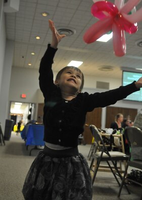 The daughter of a deployed Airman plays with a balloon animal at the quarterly deployed families dinner Sept. 19, 2011, at the McChord Field Chapel Support Center on Joint Base Lewis-McChord, Wash. (U.S. Air Force photo/Airman 1st Class Leah Young)