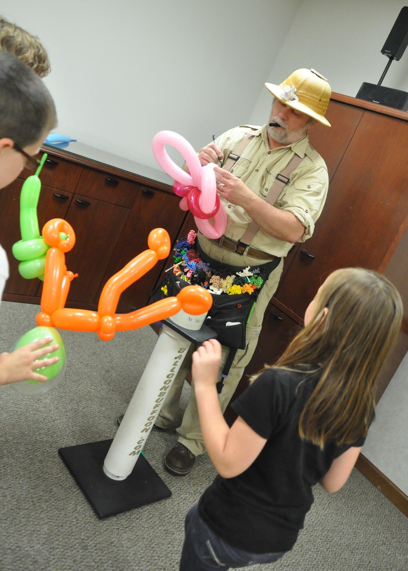 Children wait for balloon animals to be made at the quarterly Deployed Families Dinner Sept. 19, 2011, at the McChord Field Chapel Support Center on Joint Base Lewis-McChord, Wash. (U.S. Air Force photo/Airman 1st Class Leah Young)
