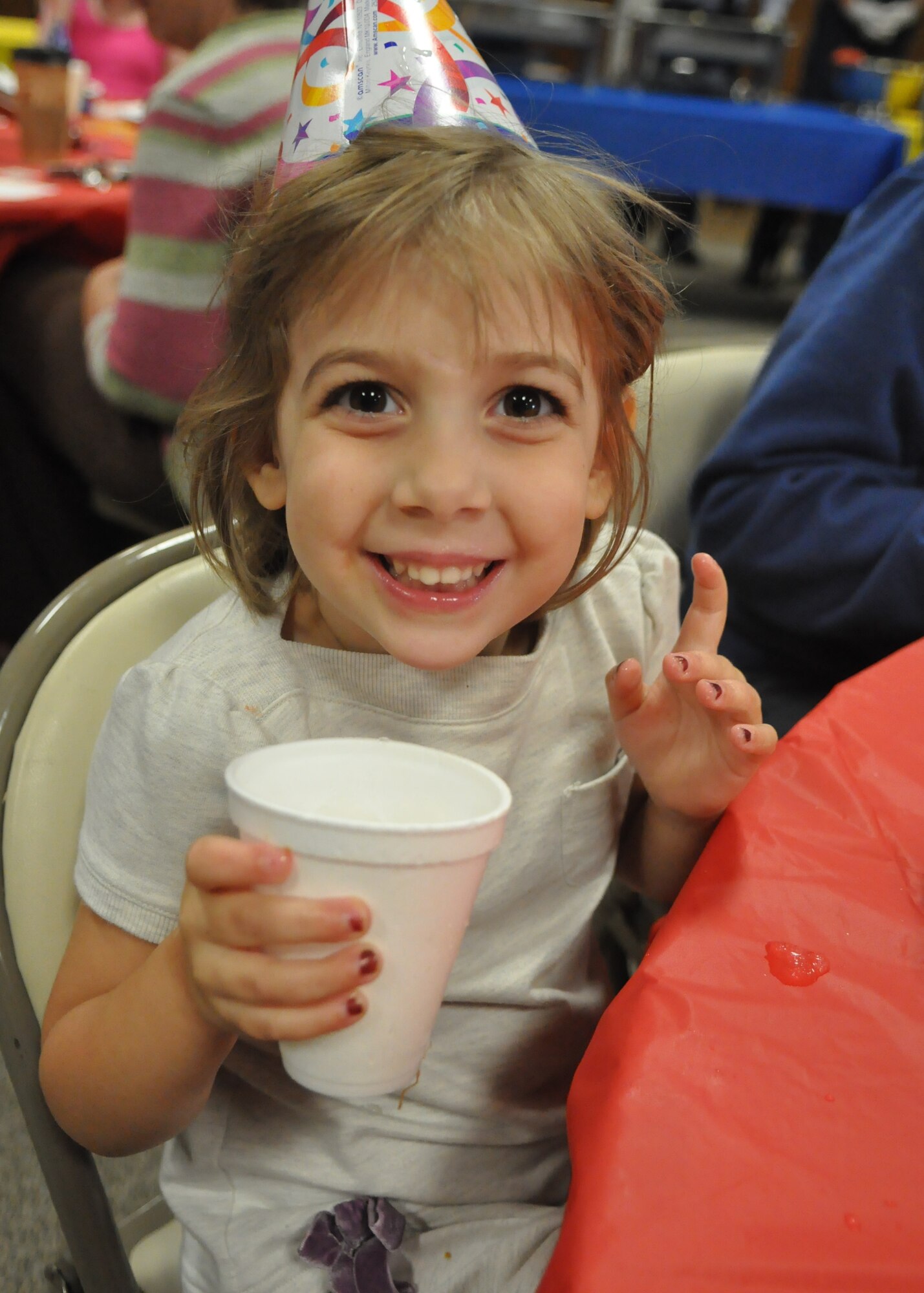 The daughter of a deployed Airman enjoys a cup of lemonade at the quarterly Deployed Families Dinner Sept. 19, 2011, at the McChord Field Chapel Support Center on Joint Base Lewis-McChord, Wash. The event, which includes face painting, a meal, and more, is held to support families who are currently dealing with a deployment of a loved one. (U.S. Air Force photo/Airman 1st Class Leah Young)