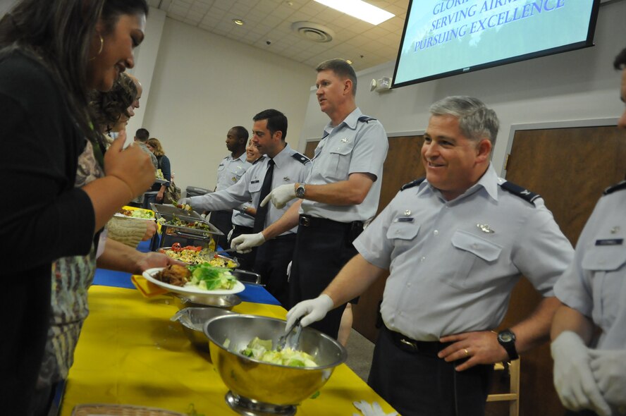 62nd Airlift Wing leadership serves food at the quarterly deployed families dinner Sept. 19, 2011, at the McChord Field Chapel Support Center on Joint Base Lewis-McChord, Wash. The event, which includes face painting, a meal, and more, is held to support families who are currently dealing with a deployment of a loved one. (U.S. Air Force photo/Airman 1st Class Leah Young) 
