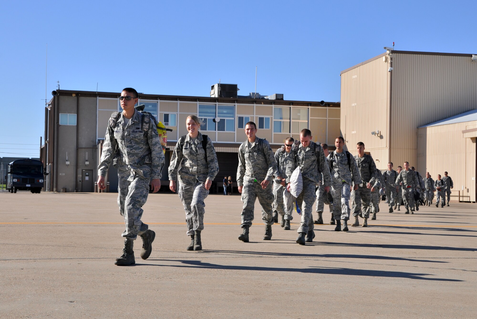 Airmen from the 419th and 388th Fighter Wings walk toward the plane that will take them to the Asia-Pacific region for a 180-day joint deployment. Nearly 200 reserve and active duty pilots, maintainers and support personnel from the two wings will provide F-16 air support in the region as part of a routine theater security package rotation. (U.S. Air Force photo/Bryan Magaña)