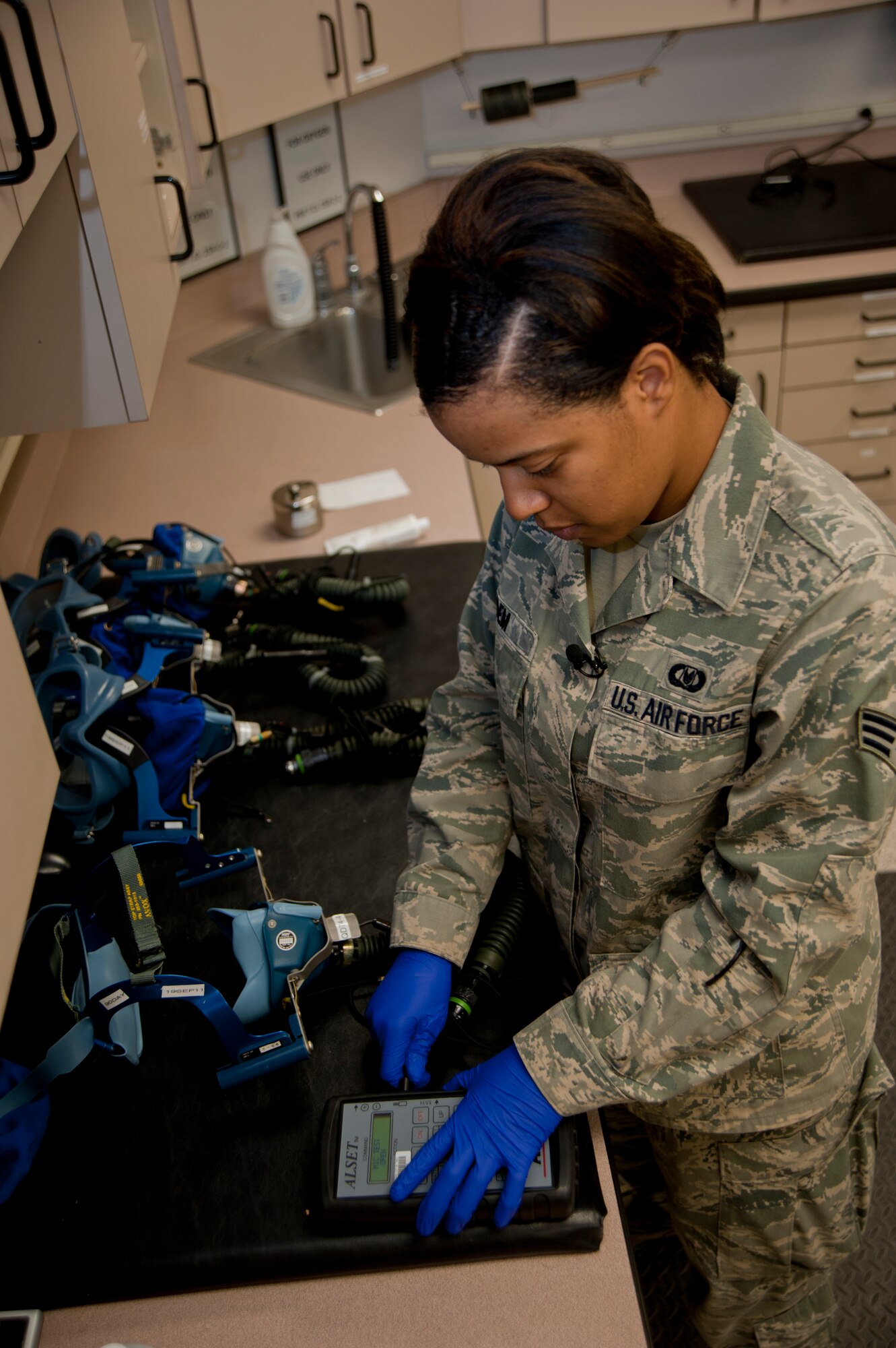Senior Airman Alicia Edem, 22nd Operations Support Squadron Aircrew Flight Equipment journeyman, performs a 30-day inspection on quick-don masks Aug. 23, 2011, McConnell Air Force Base, Kan. Edem and her shop perform maintenance and inspections on lifesaving equipment for McConnell aircrew members. (U.S. Air Force photo by Airman 1st Class Armando A. Schwier Morales)