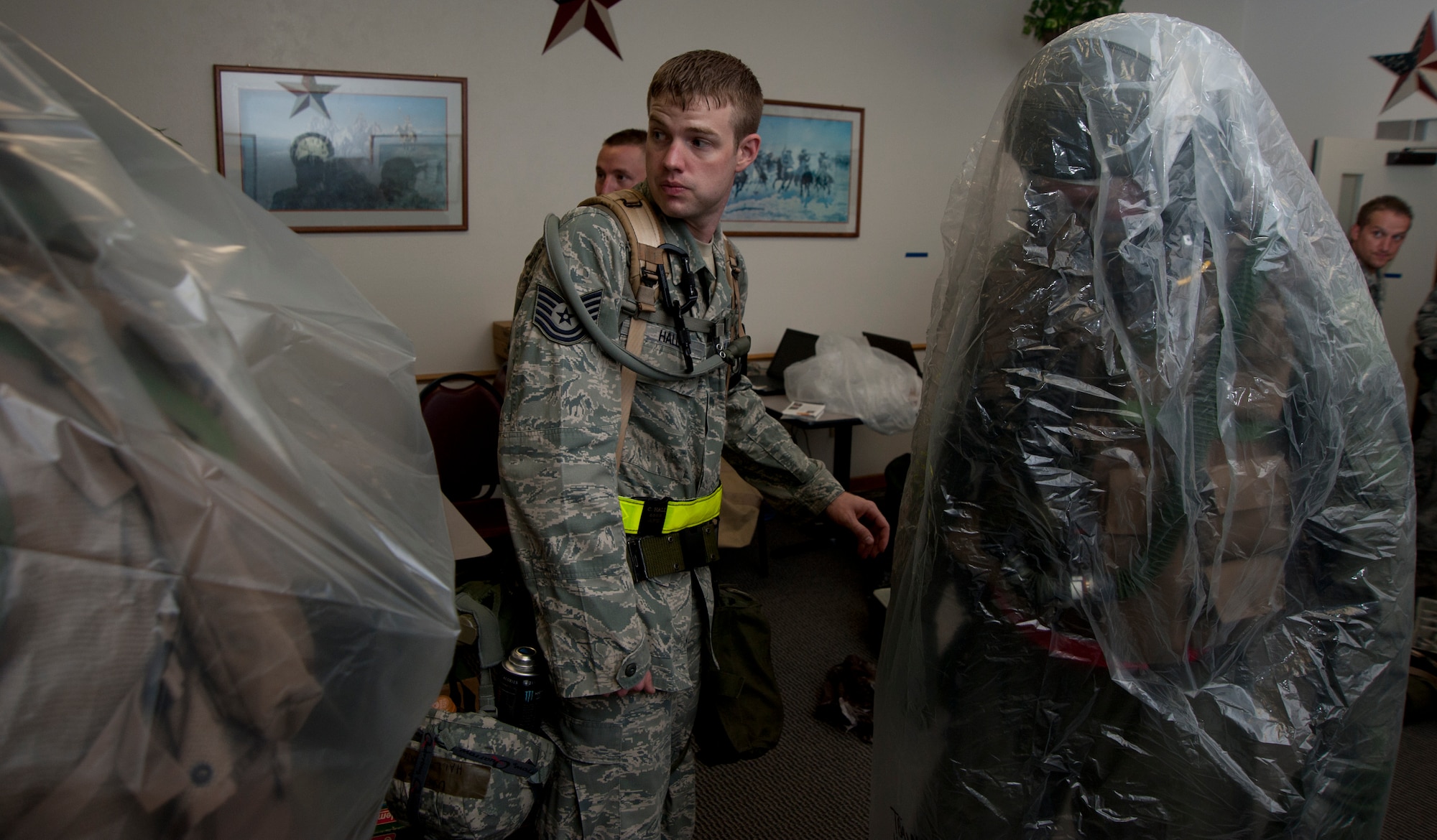 Tech. Sgt. Craig Hall, 22nd Operations Support Squadron Aircrew Flight Equipment craftsman, ensures aircrew members don their chemical ensemble correctly Aug. 7, 2011, McConnell Air Force Base, Kan. Hall participated in an ability to survive and operate operational readiness exercise to prepare for the operational readiness inspection. (U.S. Air Force photo by Airman 1st Class Armando A. Schwier Morales)