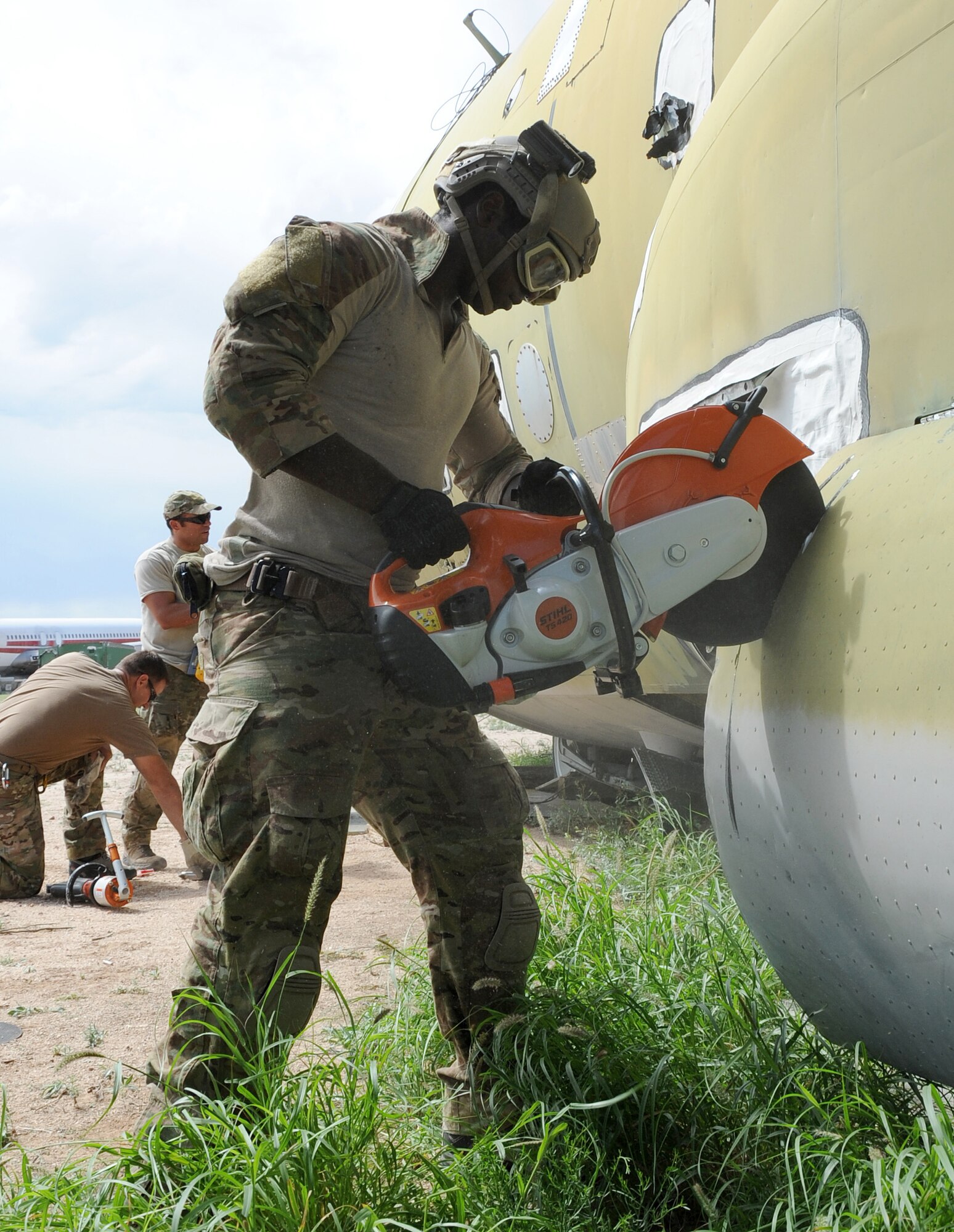 Staff Sgt. David Adams, a pararescueman with the 306th Rescue Squadron, cuts into the side of a C-130 Hercules during the squadron's ROCO training exercise. Pararescuemen with the 306th RQS recived the rare opportunity to practice extraction techniques on a C-130. (U.S. Air Force Photo/ Tech. Sgt. Luke Johnson)