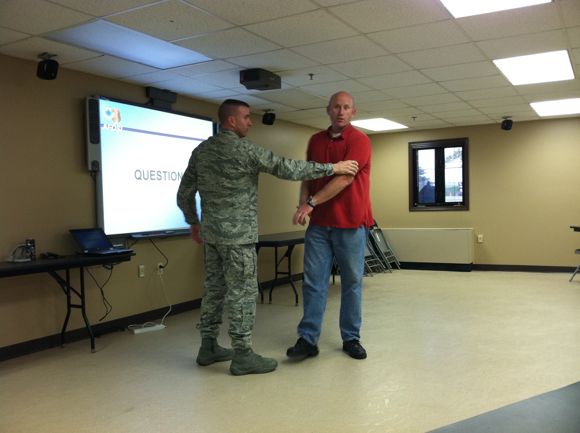 Special Agent Corey Christman with the 910th Office of Special Investigations and Major Ryan Robyn, operations officer with the 910th Security Forces Squadron, demonstrate self-defense maneuvers for a group of 910th reservists’ spouses at a class here. The class, which was requested by members of the Key Spouse Program, included instruction in situational awareness, characteristics of attackers and sexual predators as well as basic self-defense techniques. The Key Spouse Program is a support network for spouses of reservists intended to help Airman and Family Readiness and take care of military families. 