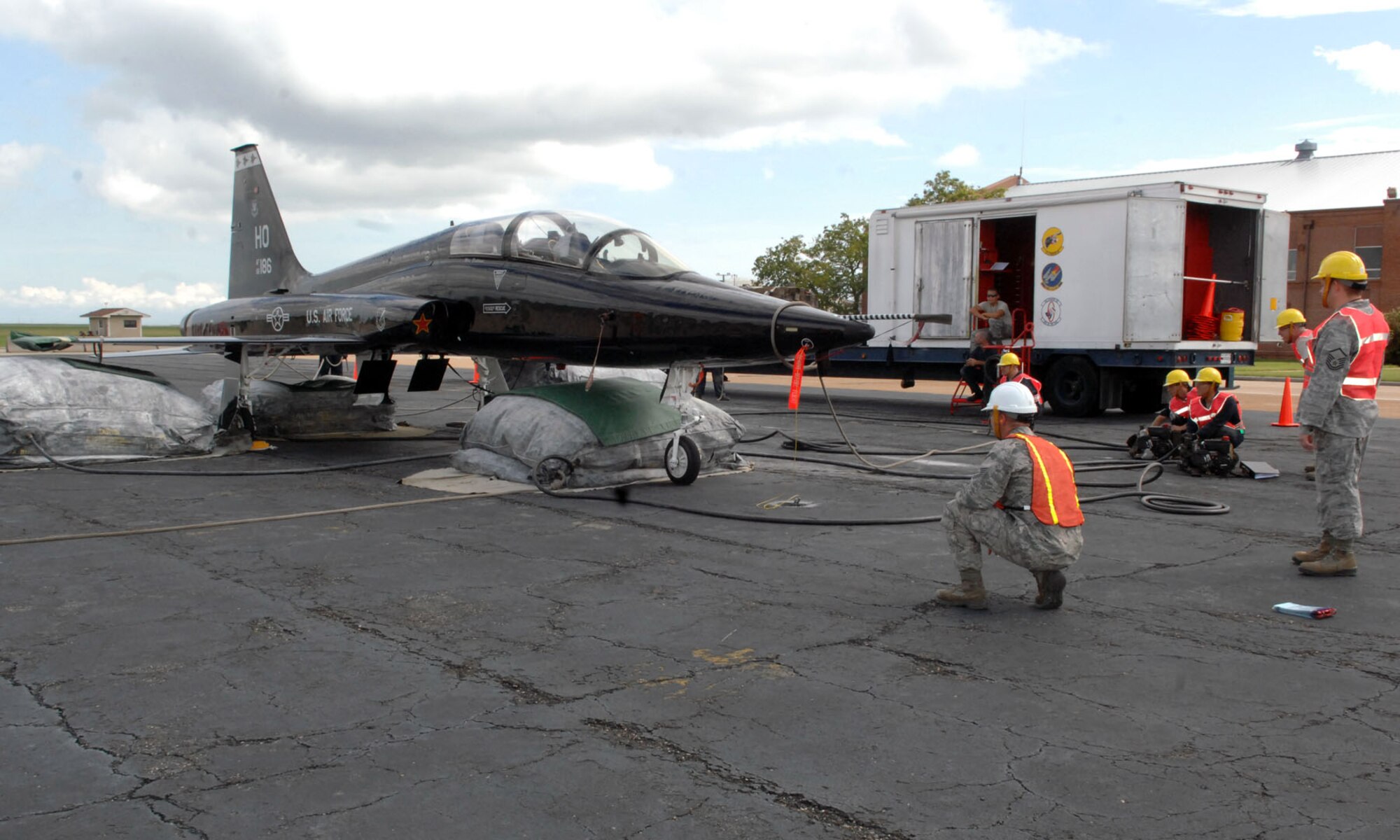 Personnel from the 1st Maintenance Squadron Packaged Maintenance Plan inflate air bags underneath the belly of a T-38 Talon during a major accident response exercise on Langley Air Force Base Va., Sept. 22, 2011. The airbags are used to prop up a jet if its landing gear fail to deploy and it can’t be towed after a crash landing. (U.S. Air Force photo by Staff Sgt. Jeff Nevison/Released)