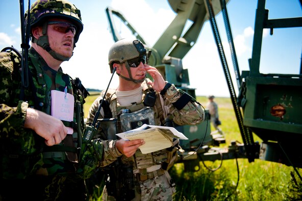 Danish army Capt. Jessper Larsen, training leader, left, and U.S. Air Force Senior Airman Jess Hager, 11th Air Support Operations Squadron joint terminal attack controller, discuss close-air support operations during Exercise Atlantic Strike 11-02 at Avon Park Air Force Range, Fla., Sept. 14, 2011. During the exercise, Larsen added a coalition element, which helped prepare new joint terminal attack controllers in dealing with various NATO troops when deployed. (U.S. Air Force photo by Staff Sgt. Jamal D. Sutter/Released) 