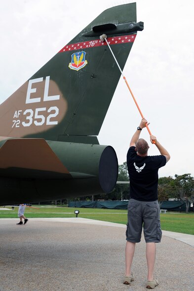 U.S. Air Force Senior Airman Jeff Brawner, 23rd Civil Engineer Squadron, scrubs an A-7 Corsair II during a Senior Airman Jason D. Cunningham Airmen Leadership School spirit project at Moody Air Force Base, Ga., Sept. 22, 2011. The project involved cleaning the various aircraft displayed at the President George W. Bush Air Park at Moody Field. The air park was officially unveiled during a ceremony May 20, 2011. (U.S. Air Force photo by Senior Airman Ciara Wymbs/Released)  