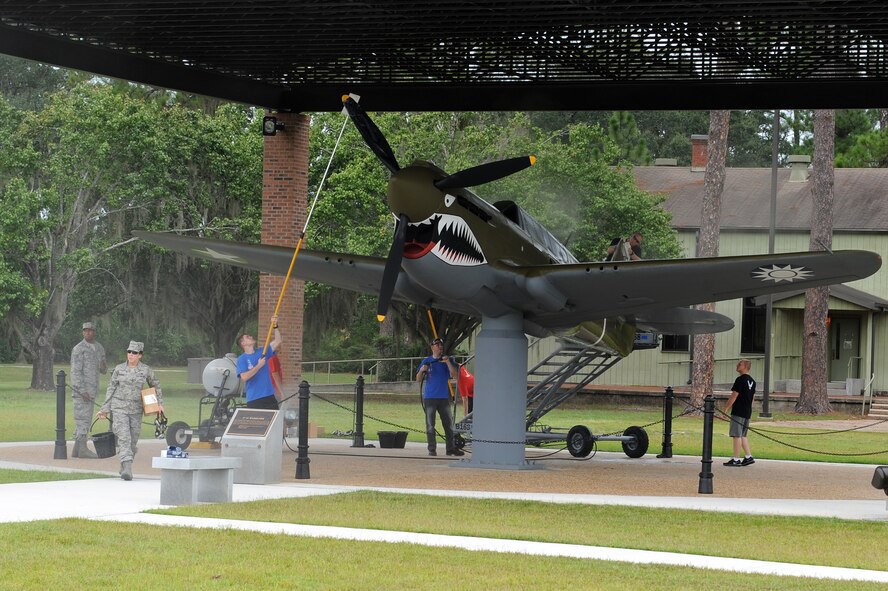 U.S. Air Force Airmen from the Senior Airman Jason D. Cunningham Airmen Leadership School class 11-G scrub and shine a P-40 Warhawk static display at heritage park at Moody Air Force Base, Ga., Sept. 22, 2011. The park is dedicated to President George W. Bush, who attended undergraduate pilot training at Moody from November 1968 to November 1969. (U.S. Air Force photo by Senior Airman Ciara Wymbs)    