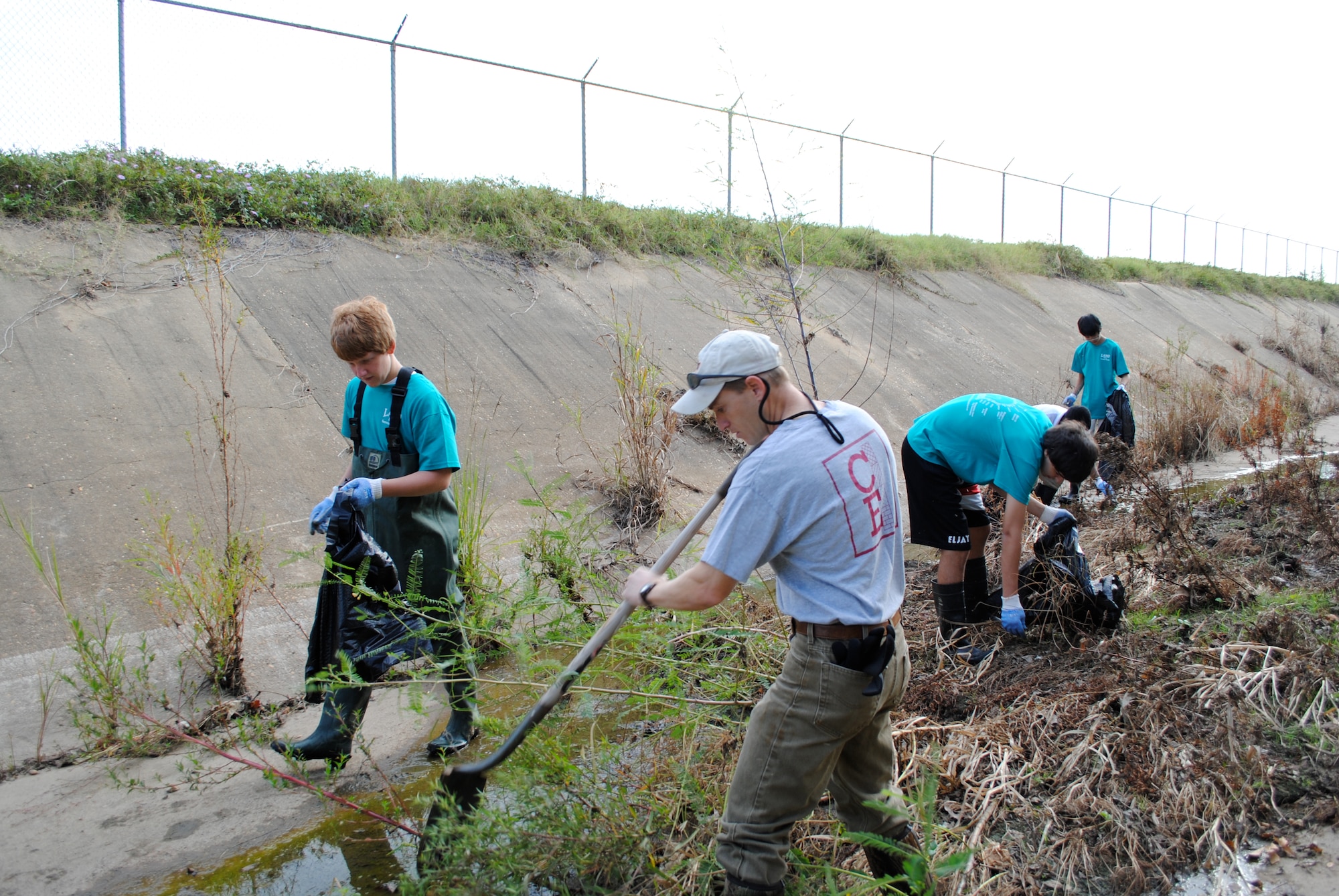 LAMP students join base environmental in cleaning up a drainage ditch outside Maxwell. (Air Force photo/Christopher Kratzer)