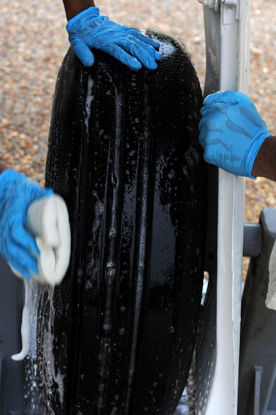 U.S. Air Force Airmen from the Senior Airman Jason D. Cunningham Airmen Leadership School class 11-G clean the wheels of an A-10A Thunderbolt as part of a spirit project at Moody Air Force Base, Ga., Sept. 22, 2011. Each ALS class commits one physical training session to scrubbing the aircraft displayed at the President George W. Bush Air Park at Moody Field. (U.S. Air Force photo by Senior Airman Ciara Wymbs/Released) 