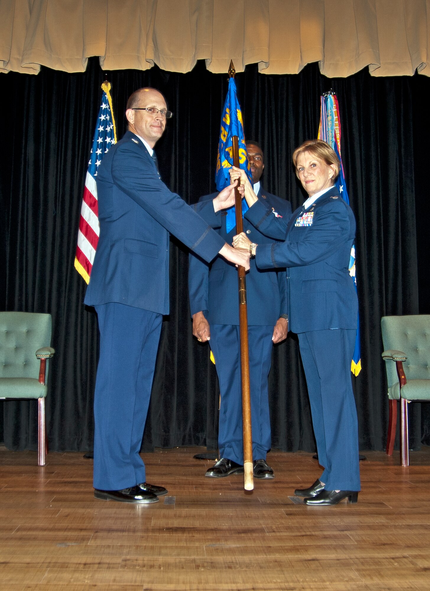Lt. Col. Barbara Persons accepts the 403rd Aeromedical Staging Squadron guidon from Col. Jay Jensen, 403rd Wing commander, in an assumption of command ceremony held Sept. 11, 2011 at the 81st Medical Group auditorium, Keesler Air Force Base, Miss.  Persons replaces former 403rd ASTS Commander Col. Guy Favaloro, who retired from the Air Force in July 2011.  Persons' comes to the 403rd Wing after returning from a deployment to Afghanistan as the 451st Expeditionary Aeromedical Evacuation Squadron commander. (U.S. Air Force photo by Dhiana McKaig)