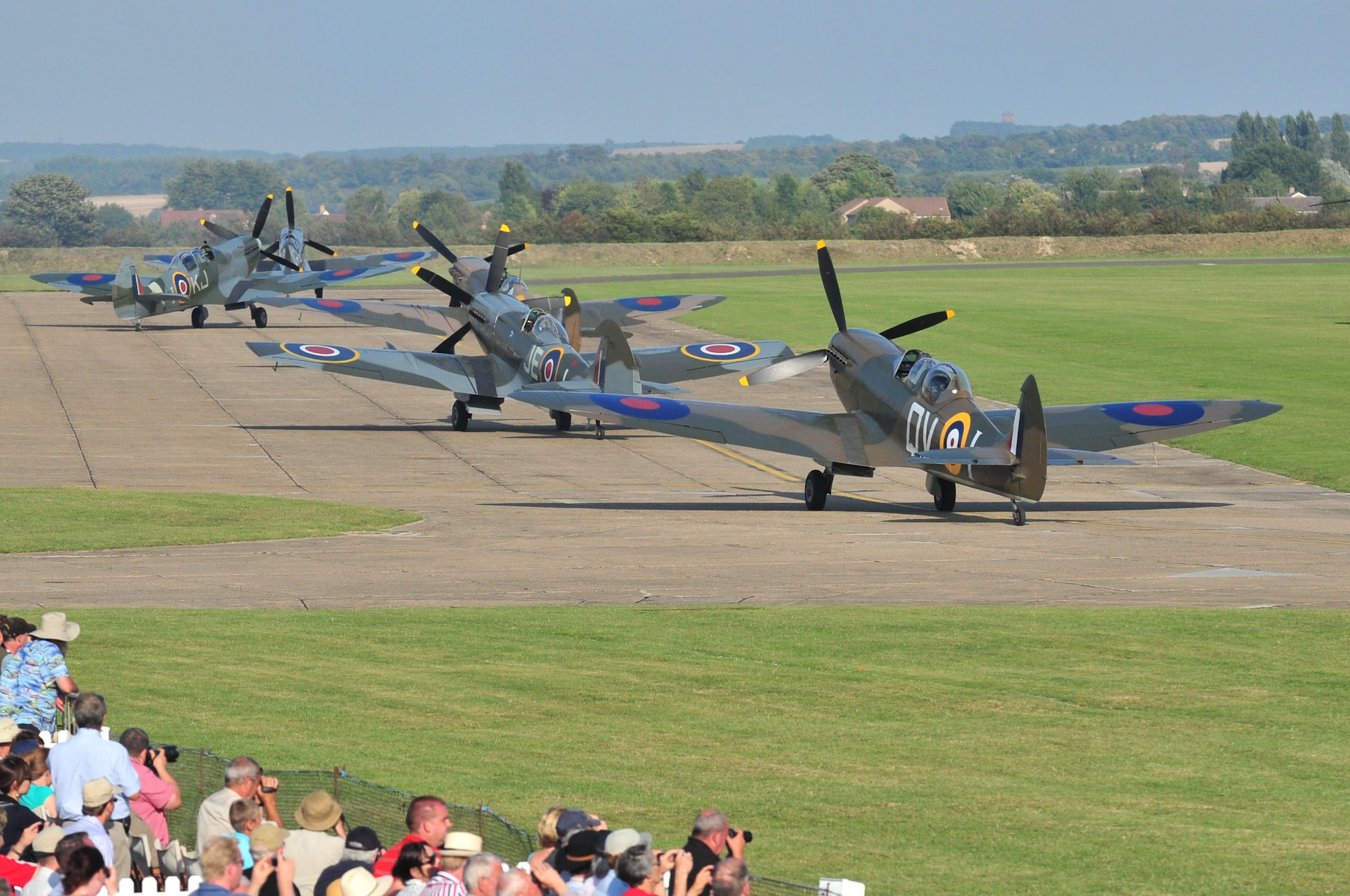 The world’s largest formation of Supermarine Spitfire aircraft taxie down the runway during the Duxford Air Show, at a village in Cambridgeshire, England, Sept. 3, 2011. The Supermarine Spitfire was the only allied aircraft in production throughout the duration of the war. Today, a replica of the aircraft stands outside the Spitfire Pub here on Seymour Johnson Air Force Base, N.C., in honor of those who gave their lives during the Battle of Britain. (U.S. Air Force photo by Senior Airman Marissa Tucker)