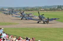 The world’s largest formation of Supermarine Spitfire aircraft taxie down the runway during the Duxford Air Show, at a village in Cambridgeshire, England, Sept. 3, 2011. The Supermarine Spitfire was the only allied aircraft in production throughout the duration of the war. Today, a replica of the aircraft stands outside the Spitfire Pub here on Seymour Johnson Air Force Base, N.C., in honor of those who gave their lives during the Battle of Britain. (U.S. Air Force photo by Senior Airman Marissa Tucker)