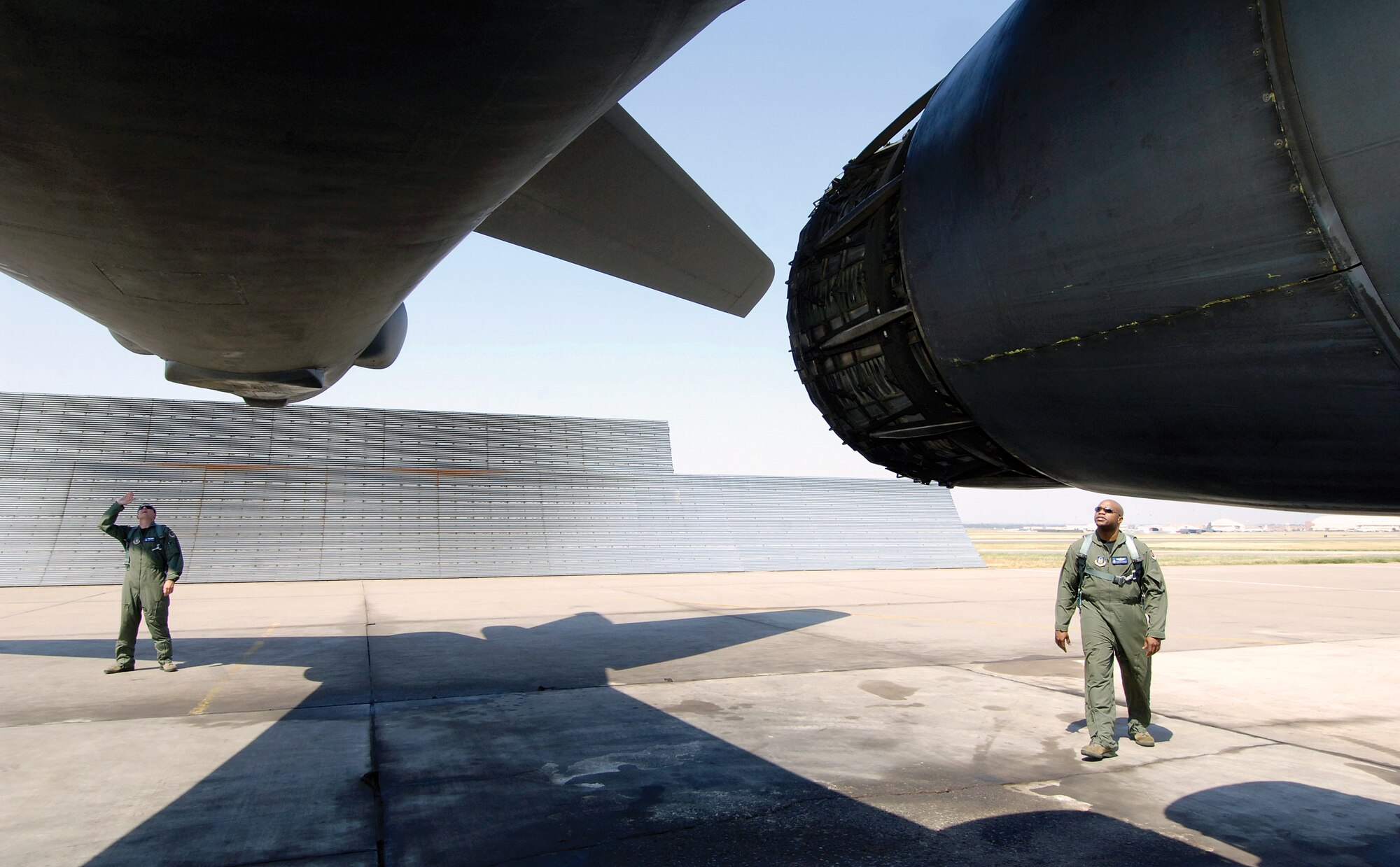 Tinker’s 10th Test Flight Squadron B-1 crew members Maj. Matthew ‘Hackey’ Grimes, left, and Maj. Terrance ‘Lid’ Safforld conduct a pre-flight check Aug. 31 of a unique bomber before returning the aircraft to Edwards Air Force Base, Calif. The B-1, used for developmental testing, required programmed depot maintenance scheduled time cut in half; something three bases and several Tinker organizations pulled together to accomplish, even returning the jet ahead of schedule. (Air Force photo by Margo Wright)