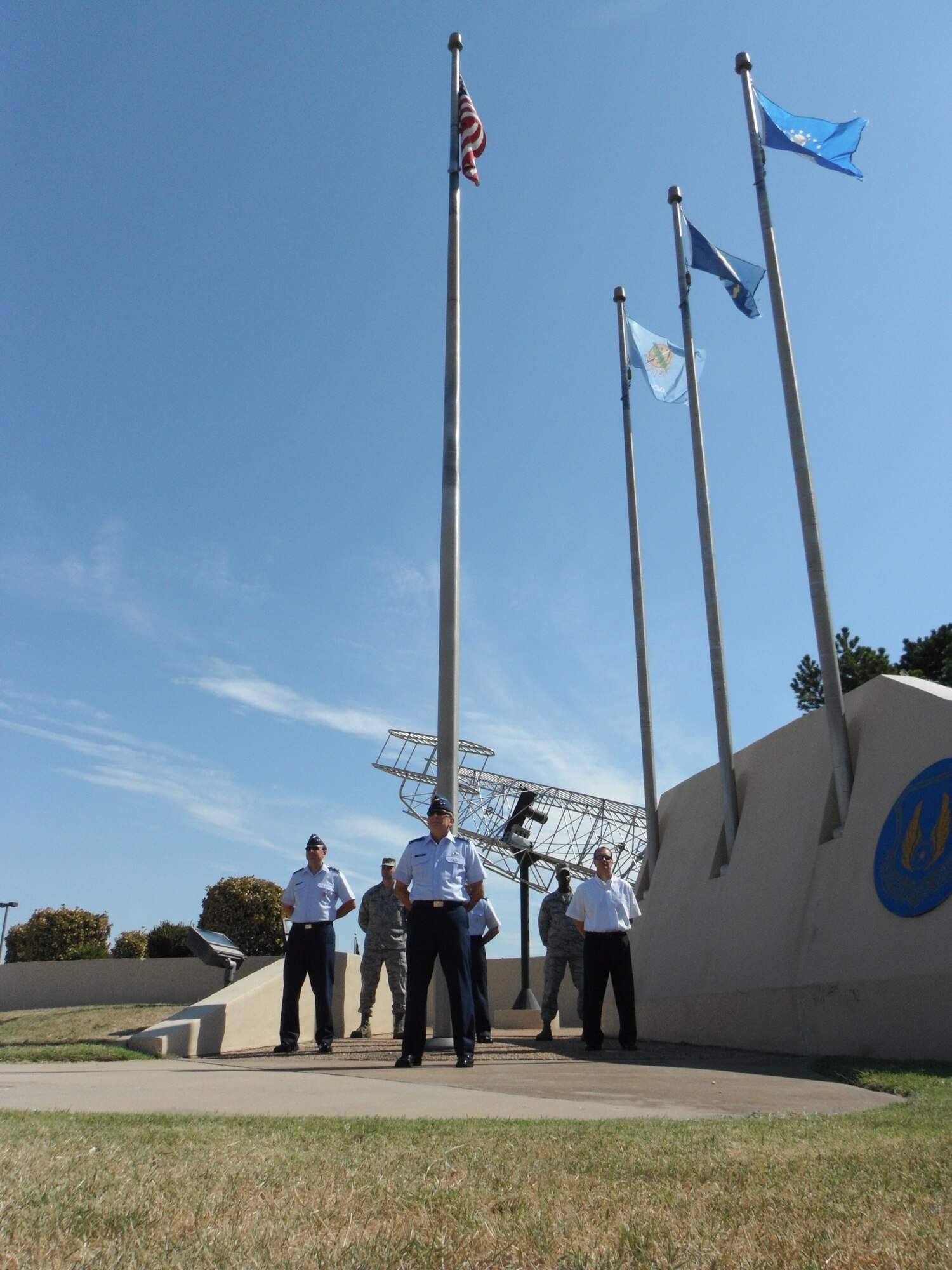 In honor of the lives lost on that September morning 10 years ago, members of Team Tinker stand vigil at the Wright Flyer Memorial Park. Four individuals at a time, representing the four separate attacks, stood watch around the flagpole for 24-hours. Approximately 220 Team Tinker personnel participated in the vigil. Oklahoma City Air Logistics Center leadership commencing the event were Maj. Gen. David Gillett, OC-ALC commander, center; Ross Marshall, OC-ALC executive director, right; and Maj. Gen. Bruce A. Litchfield, Air Force Materiel Command, special assistant, left. In back, from left, are Col. Michael B. Tannehill, 76th Aircraft Maintenance Group commander; Col. Bob LaBrutta, 72nd Air Base Wing commander; and Col. Cedric George, 76th Maintenance Wing commander. (Air Force photo by Brion Ockenfels)