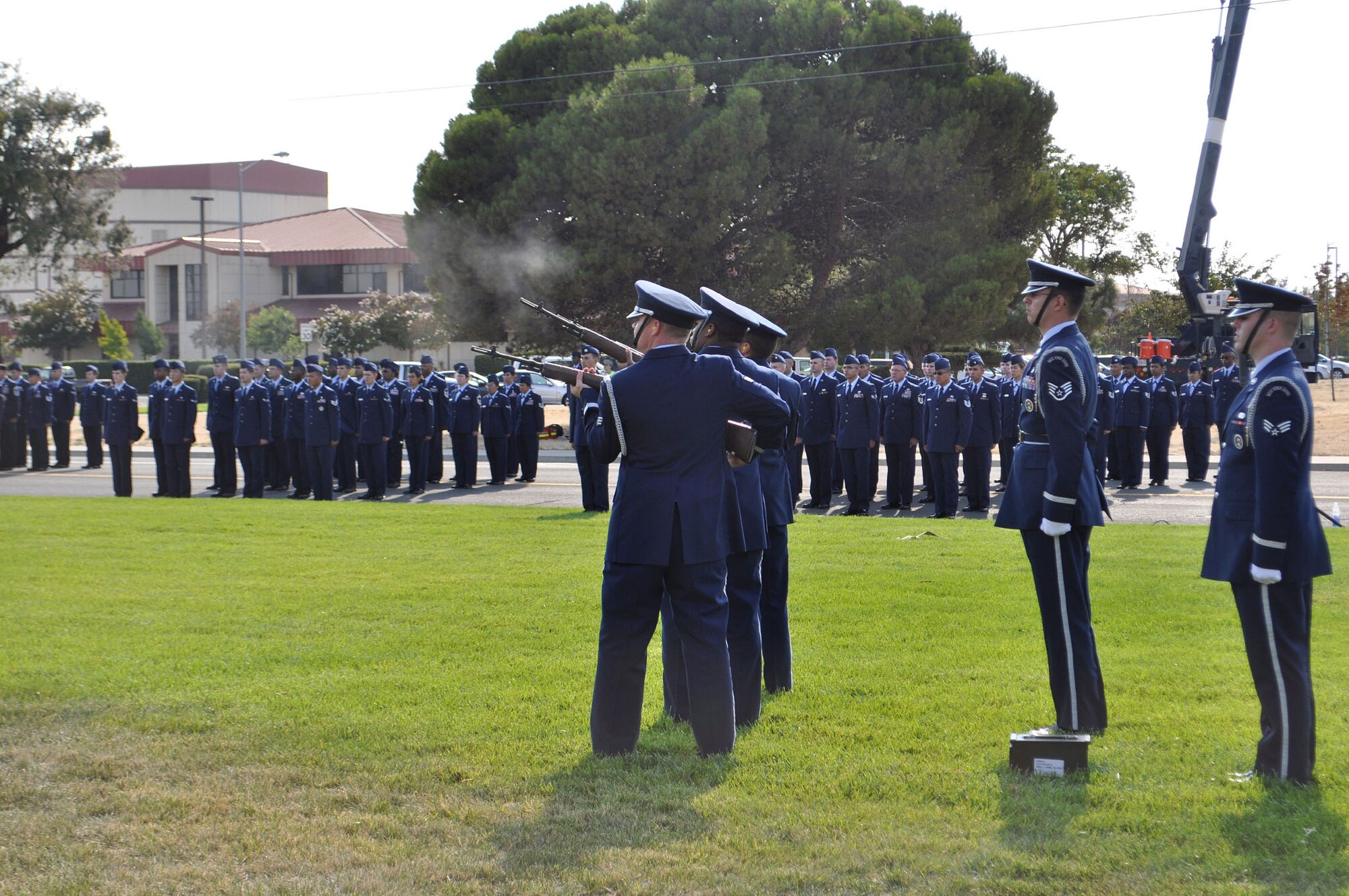 TRAVIS AIR FORCE BASE, Calif. --The Travis Air Force Base Honor Guard fires a 21-gun volley to signal the sounding of retreat Sunday, the 10th anniversary of 9/11. More than 400 family, friends and retirees joined Travis Airmen to remember those who perished 10 years ago, in the worst terrorist attack on U.S. soil. About 120 Airmen stood in formation and rendered honors at the end of the duty day, a tribute as well, to their brothers and sisters in arms, who have died in the wars in Iraq and Afghanistan, launched shortly after the 2001 attacks. (U.S. Air Force photo/Senior Master Sgt. Ellen L. Hatfield)
