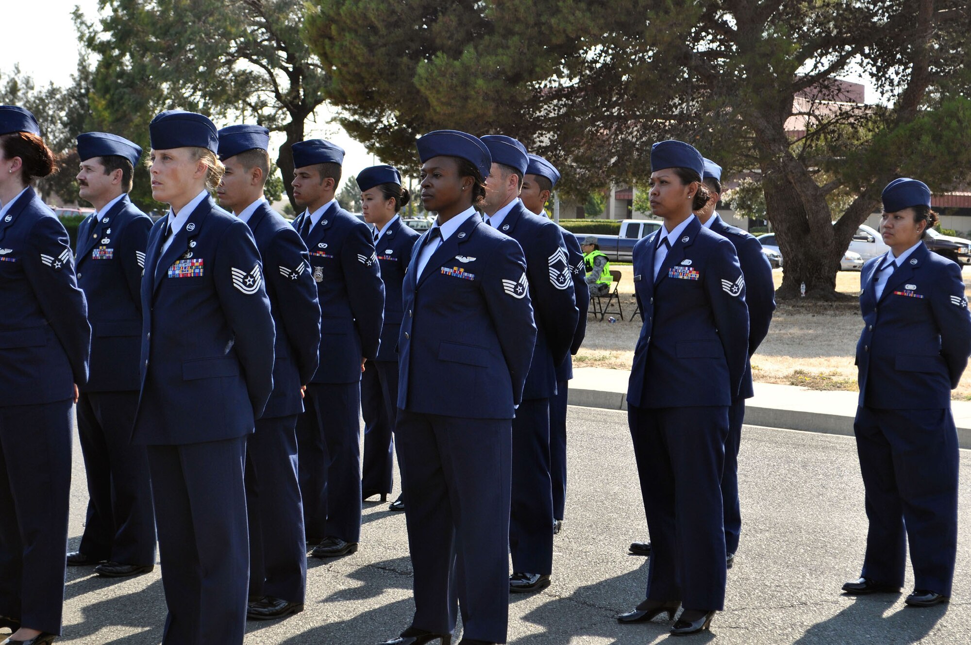 TRAVIS AIR FORCE BASE, Calif. -- Airmen of the 349th Air Moblity Wing stand in formation for a 10th anniversary 9/11 retreat ceremony Sunday. Around the world, ceremonies remembered those who died on that day in 2001, a day that changed the world forever, and plunged us into a war still going on today. These Airmen also paid tribute to, and won't forget, all their brothers and sisters in military service, who have died in Iraq, Afghanistan, and around the world, as a result of 9/11. Speaker for the the retreat was Col. Jay Flournoy, 349th AMW commander, who was a young major on duty at the Pentagon 9/11, 2001, where American Airlines Flight 77 plowed into the building, killing 59 on board, 125 in the Pentagon. Followed by a 21-gun volley, retreat was sounded, the flag was retired, and a bagpiper played "Amazing Grace" to end this solemn and reflective duty day for Travis Air Force Base. (U.S. Air Force photo/Senior Master Sgt. Ellen L. Hatfield)