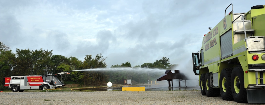 Firefighters from the 633rd Civil Engineer Squadron douse a mock T-38 fire during a major accident response exercise at Langley Air Force Base, Va., Sept. 22, 2011. Firefighters arrived on scene for a mock aircraft crash and use their expertise to control the incident. (U.S. Air Force photo by Airman 1st Camilla Griffin/Released)