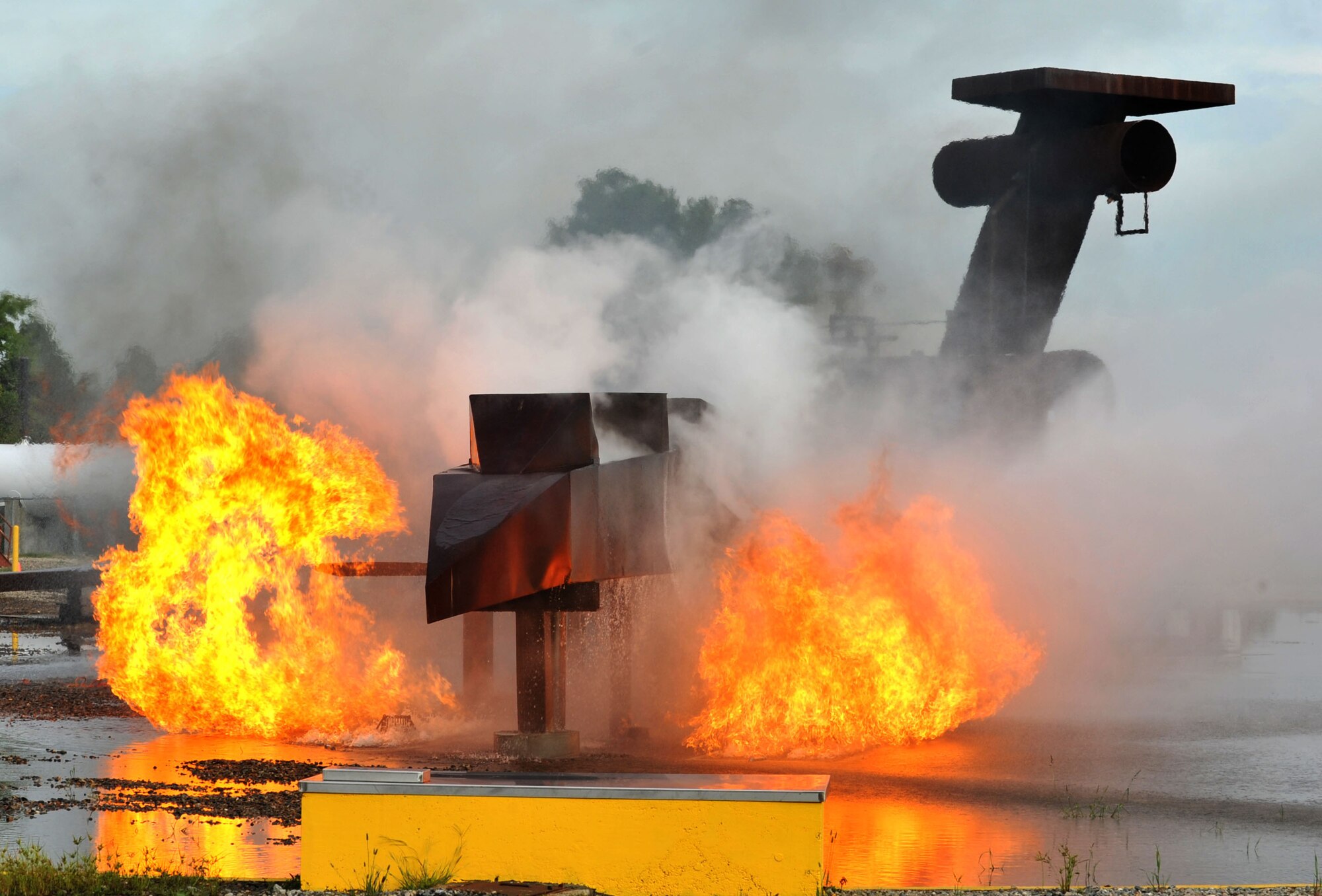 Flames from the mock aircraft are controlled by the 633rd Civil Engineer Squadron firefighters during a major accident response exercise at Langley Air Force Base, Va., Sept. 22, 2011. The scenario was that the aircraft collided with two passenger buses before coming to a stop near the fire training area on base. (U.S. Air Force photo by Airman 1st Camilla Griffin/Released)