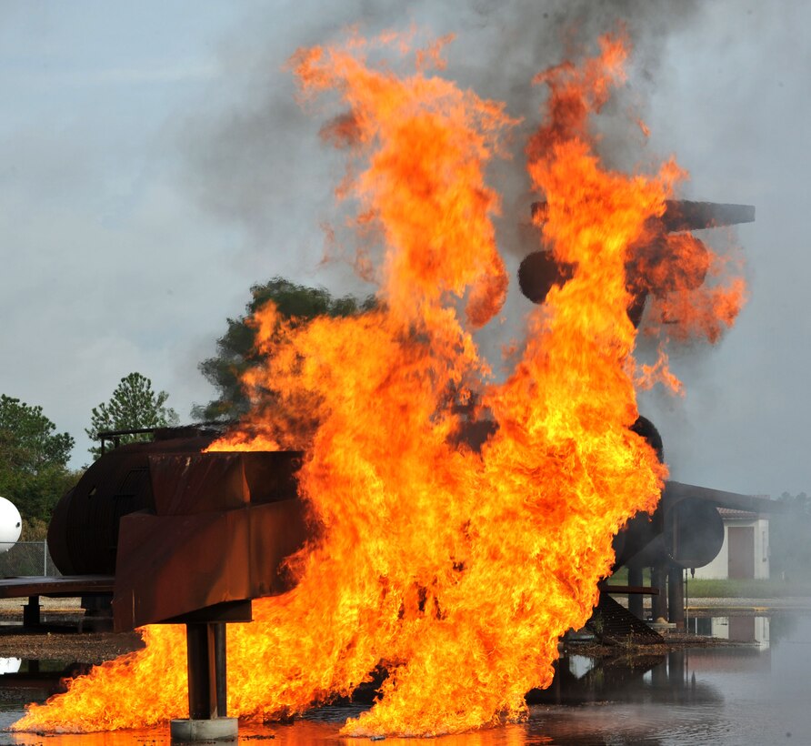 A mock aircraft is ignited during the major accident response exercise at Langley Air Force Base, Va., Sept. 22, 2011. The aircraft was set ablaze to evaluate first responders’ ability in intense situations. (U.S. Air Force photo by Airman 1st Camilla Griffin/Released)