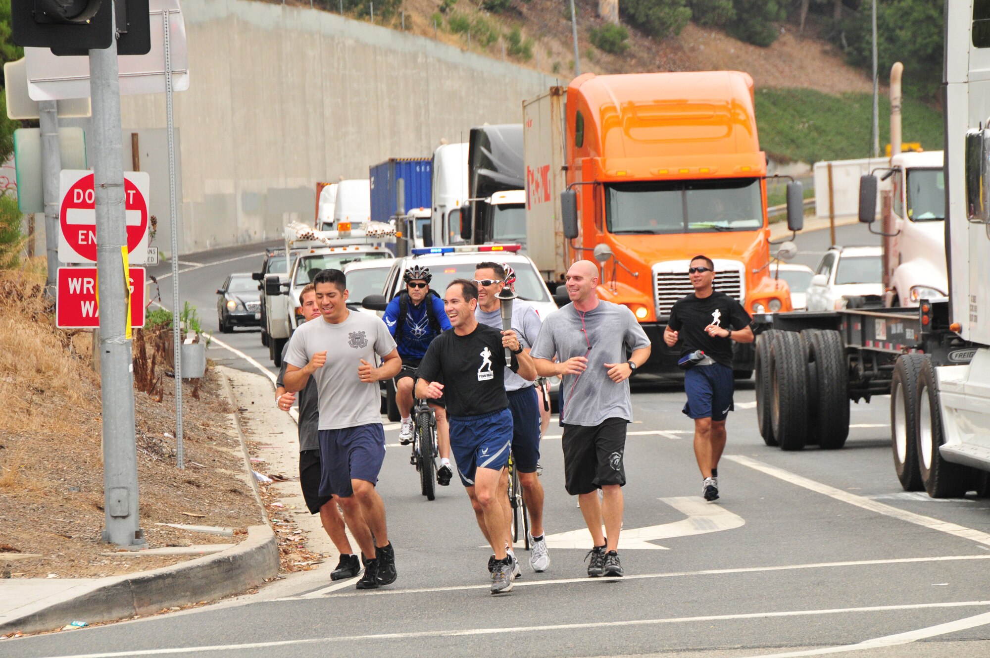 Runners are escorted across the Vincent Thomas Bridge into San Pedro. More than 50 runners representing all branches of the military services commemorated National POW/MIA Recognition Day with a 24-hour 60-plus-mile torch relay run that culminated in a wreath-laying ceremony, Sept. 16. (Photo by Lou Hernandez)