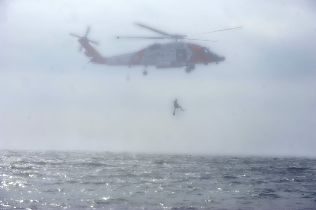 The Elizabeth City Coast Guard Air Station rescue team uses an HH-60G Pave Hawk to exercise an overwater search and rescue operation at Langley Air Force Base, Va., Sept. 22, 2011. The exercise tested processes and procedures if a pilot would have to eject over water. (U.S. Air Force photo by Staff Sgt. Antoinette Gibson/Released)
