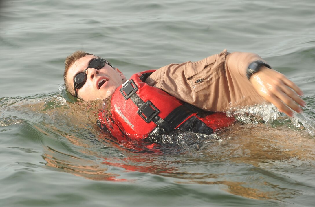 U.S. Air Force Staff Sgt. Adam Derycke, 1st Operation Support Squadron, Survival Evasion Resistance and Escape specialist, swims to a survivor during a search and rescue exercise at Langley Air Force Base, Va., Sept. 22, 2011. The purpose of this exercise was to evaluate the base's ability to respond to an aircraft mishap. (U.S. Air Force photo by Staff Sgt. Antoinette Gibson/Released)